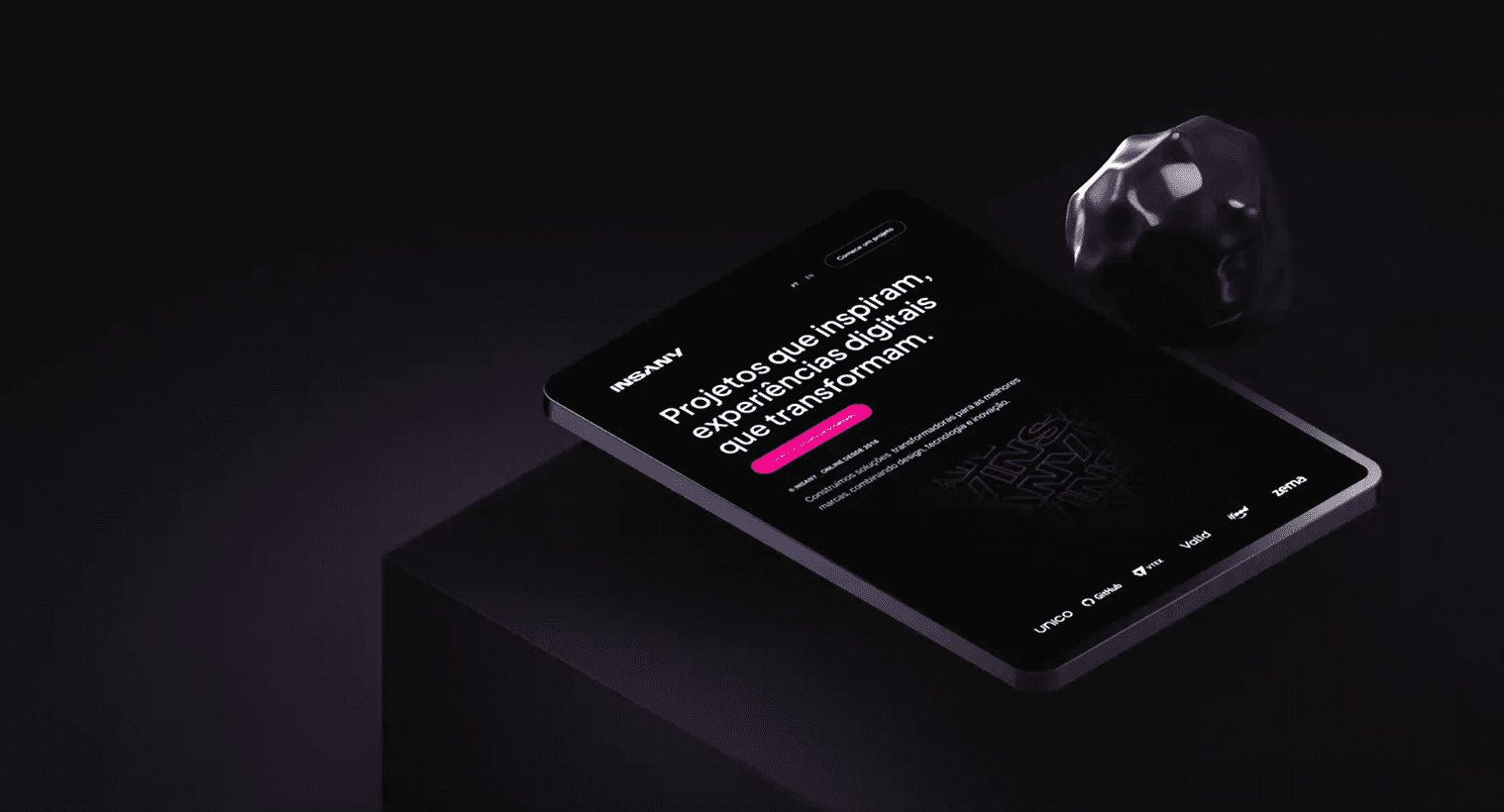 Black and white image of people working at a table with laptops, showing hands gesturing during discussion of digital content displayed on screens, with fabrica® logo in the corner.