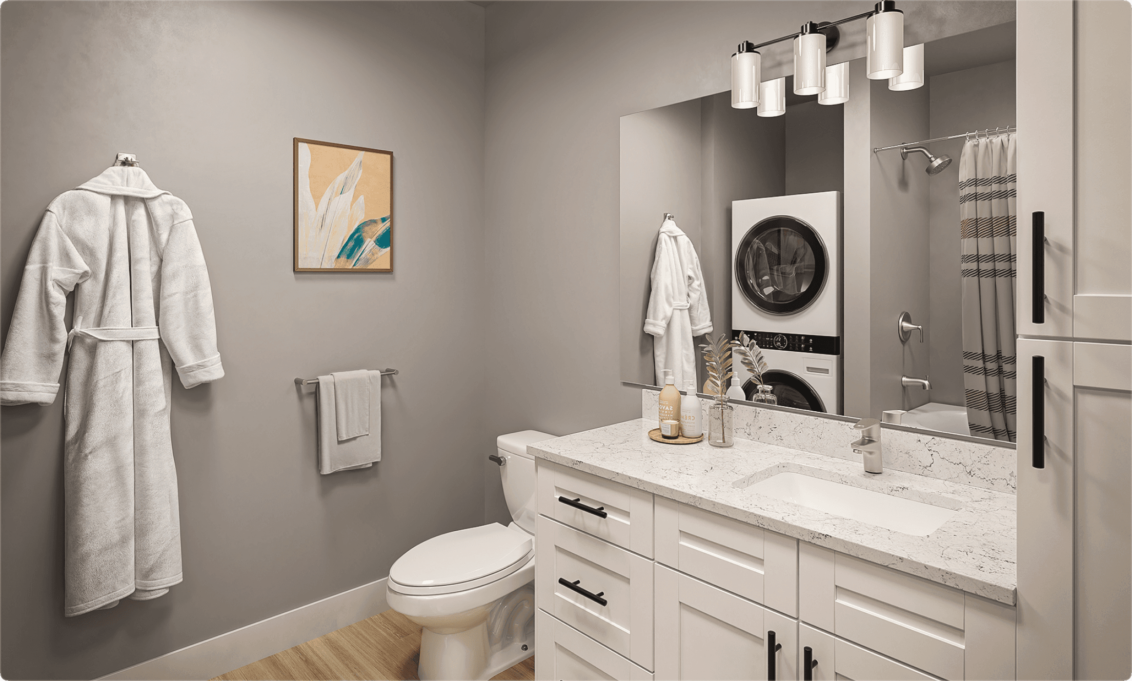 Luxury apartment bathroom with white quartz vanity, large mirror, and in-unit stacked washer and dryer.