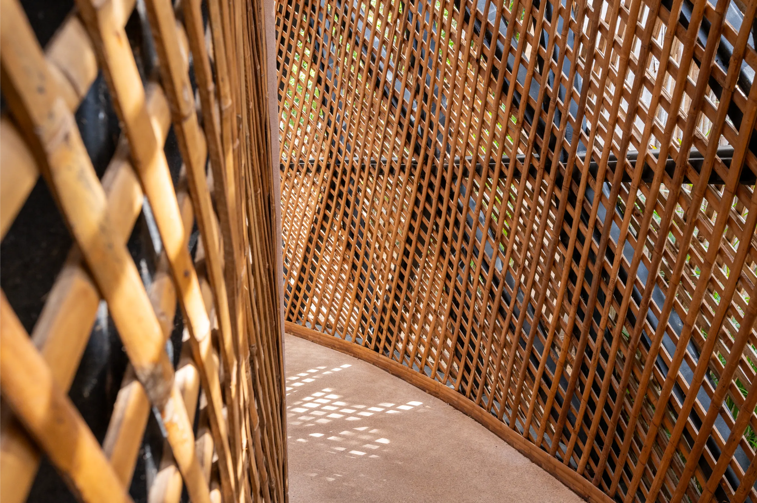 Close-up detail of the parametric bamboo facade at Aflora, showing the intricate diamond lattice pattern and the structural layering that creates a visual Moiré effect.