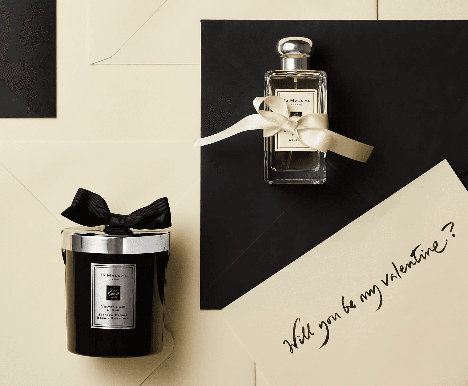 Stylish perfume bottles on a neutral background, featuring a black lid and decorative ribbon. Elegant composition.