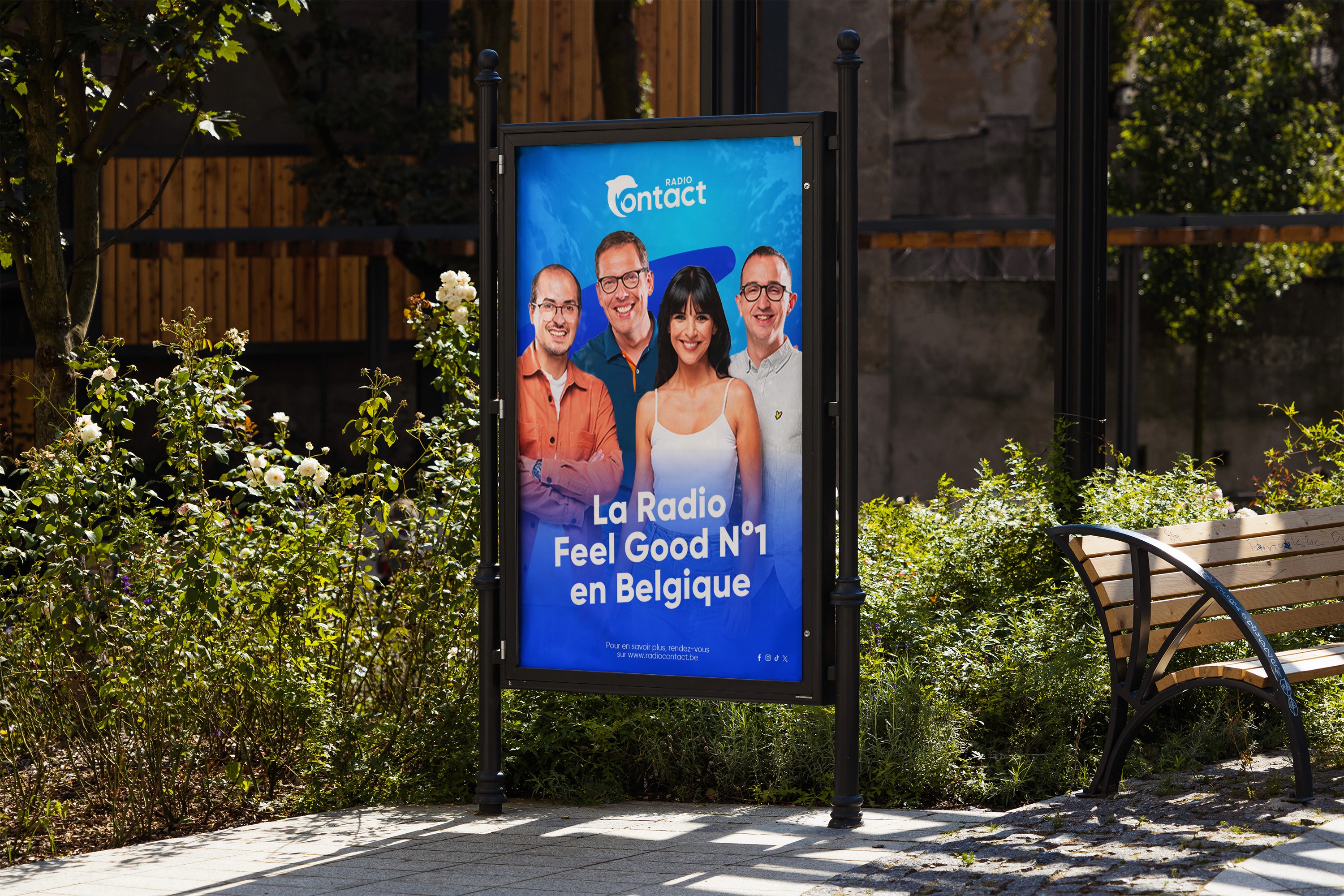 Tower of red-orange business cards on a peach surface, the top card displaying a white ODE logo in the top corner and small white contact details beneath.
