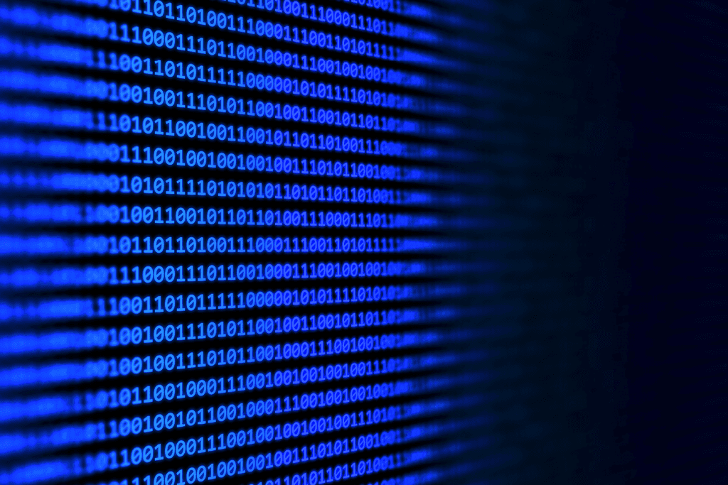 Código binário em tela azul representando dados digitais e sistemas de tecnologia da informação - FindUP - Vazamento de dados