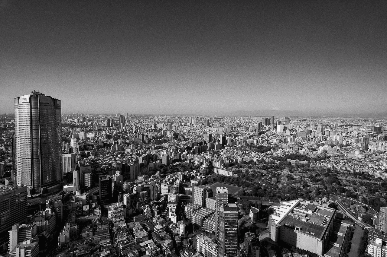 Monochrome aerial view of Tokyo’s vast cityscape, symbolizing long-term strategic vision and global scaling expertise for Fundcycle Law.