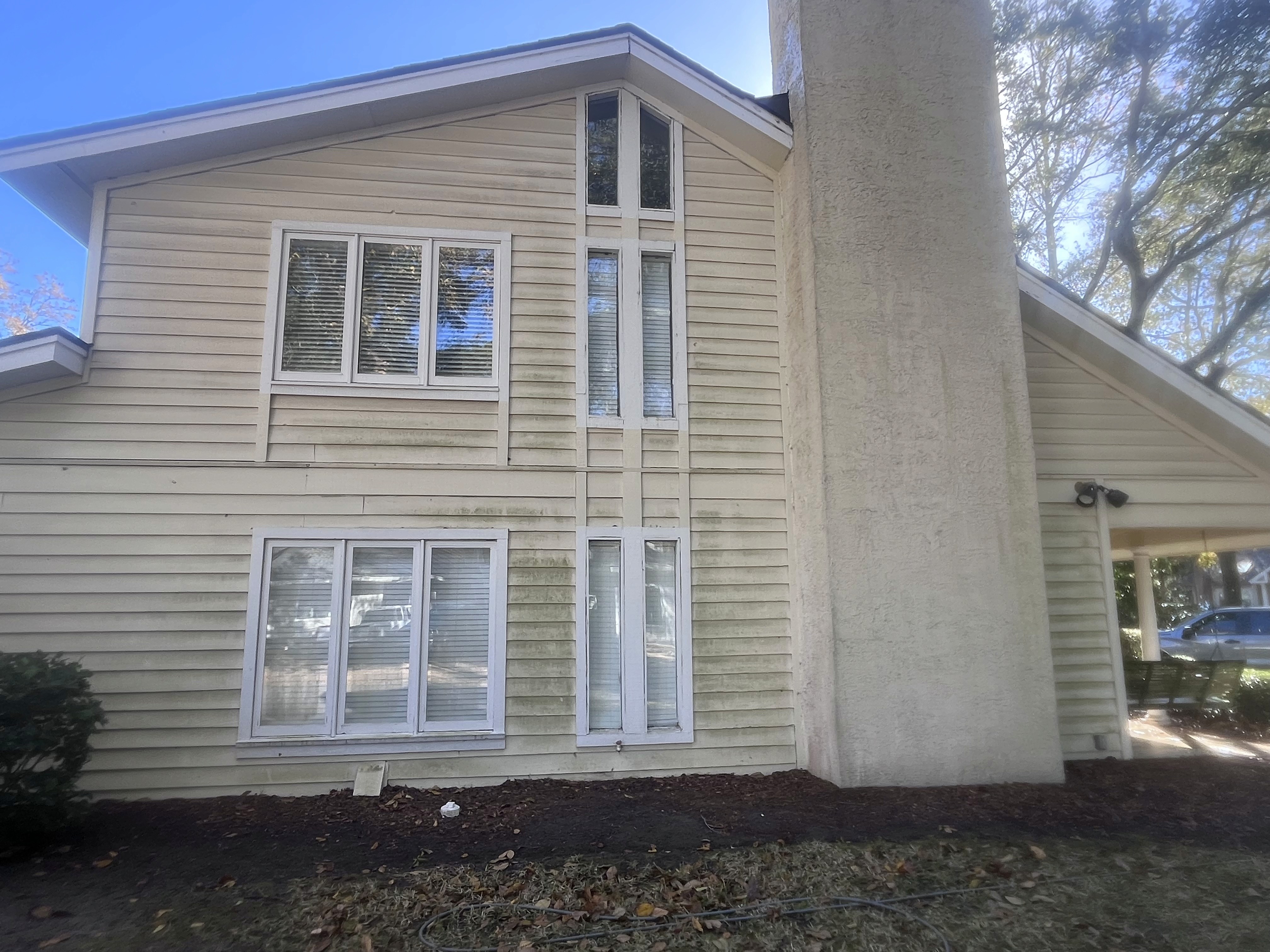 Before and after—home siding soft washed, surface free from algae and grime