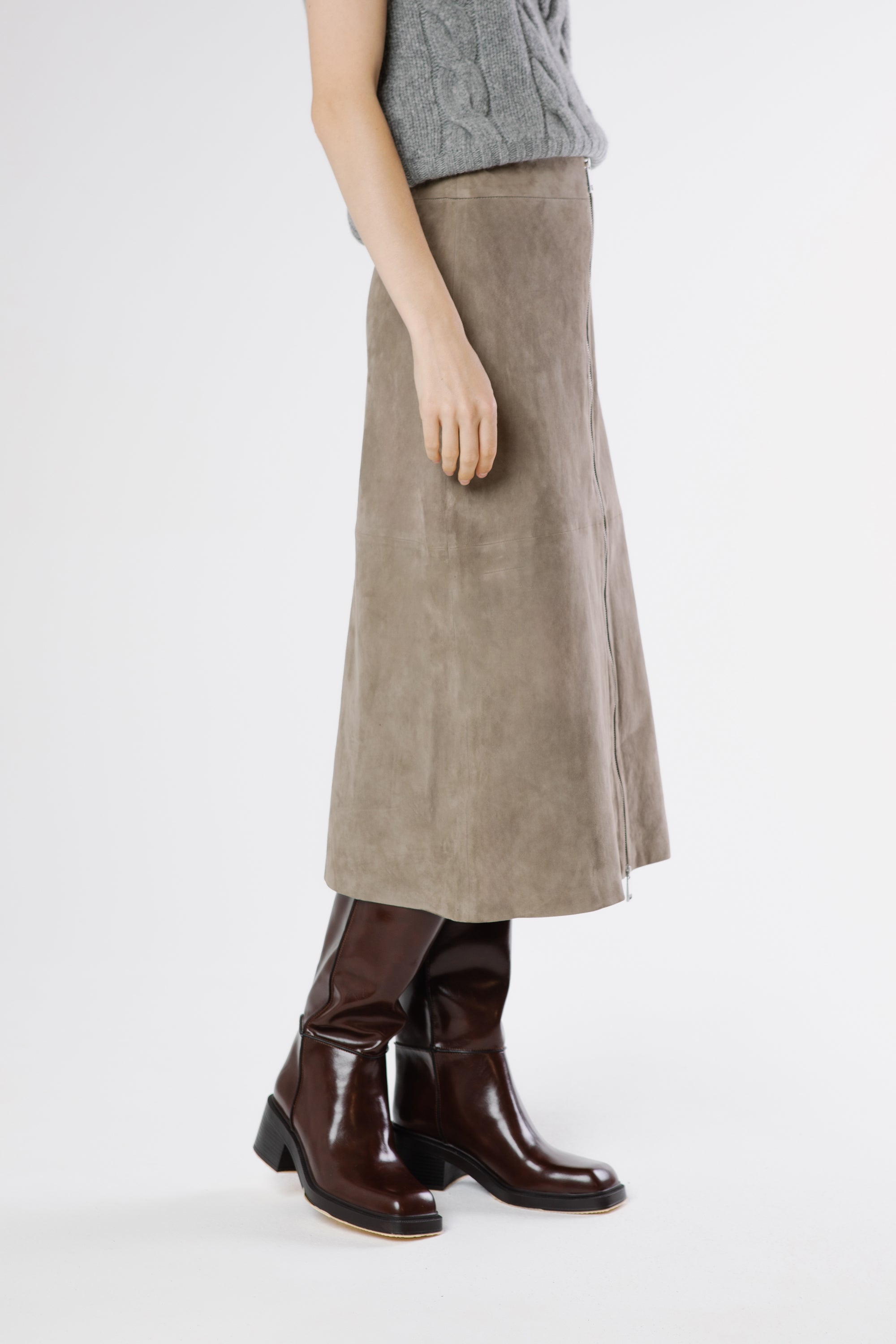 Close-up of Zara suede midi skirt in drizzle grey showing velvety suede texture and front zipper detail.