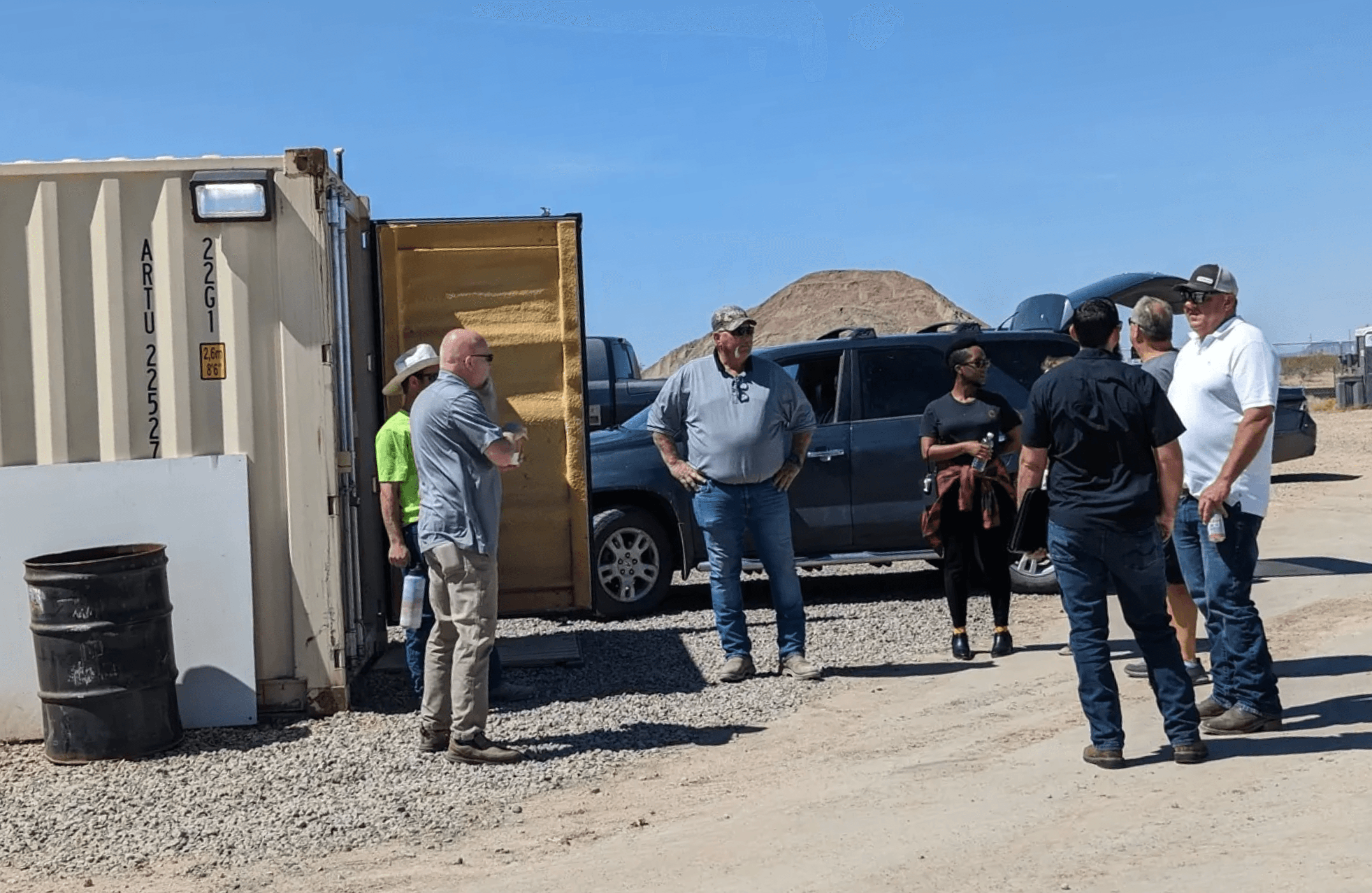 Silhouette of a researcher examining a slide under a microscope with a blue background.
