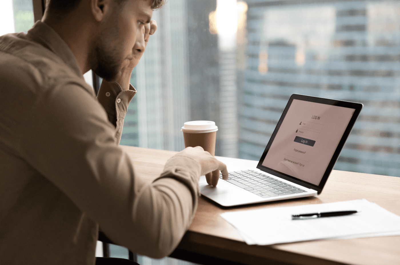 Thoughtful young man worker, student sit by laptop, prepare to input personal data entering account