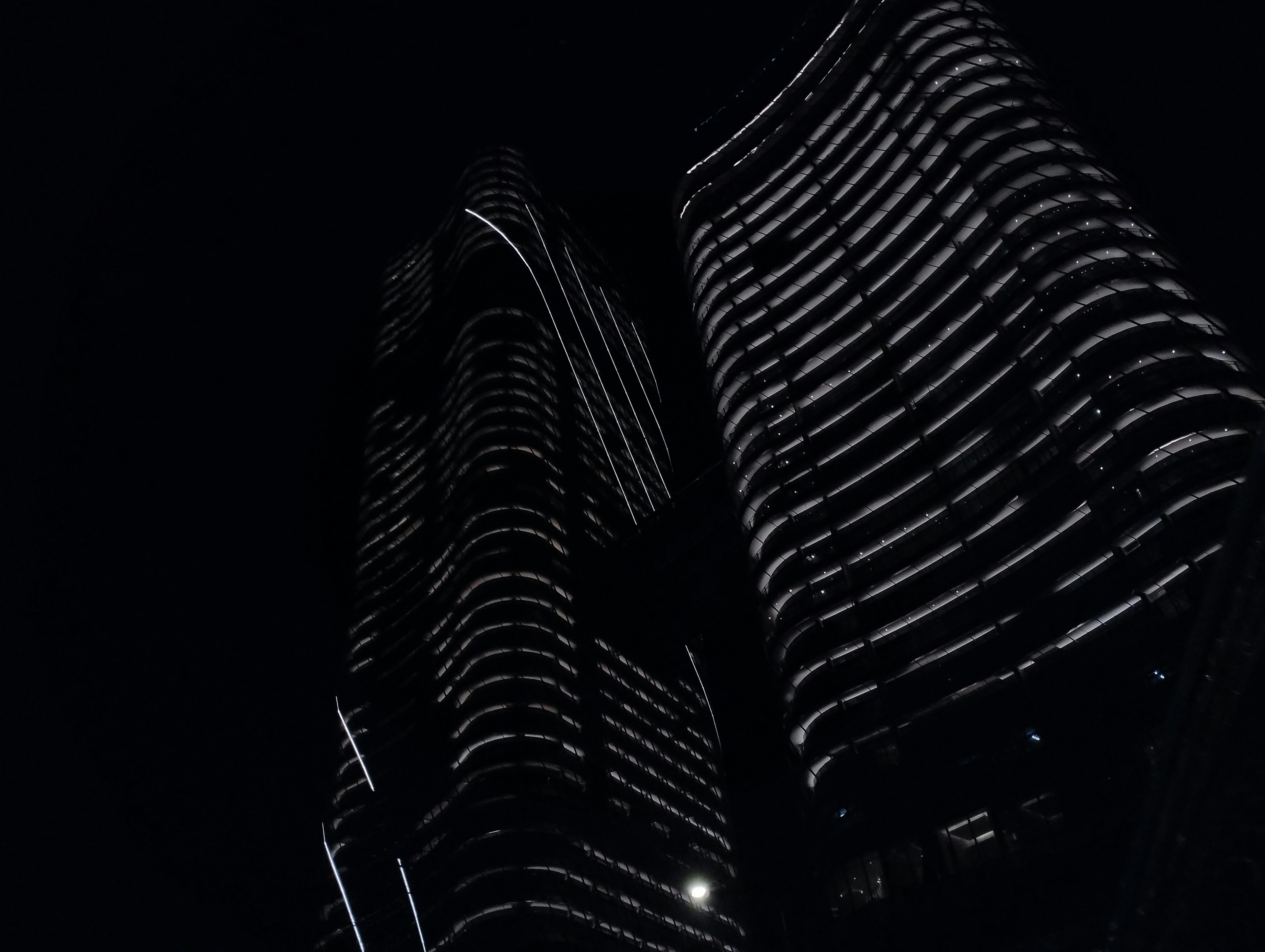 a black and white photo of two tall buildings
