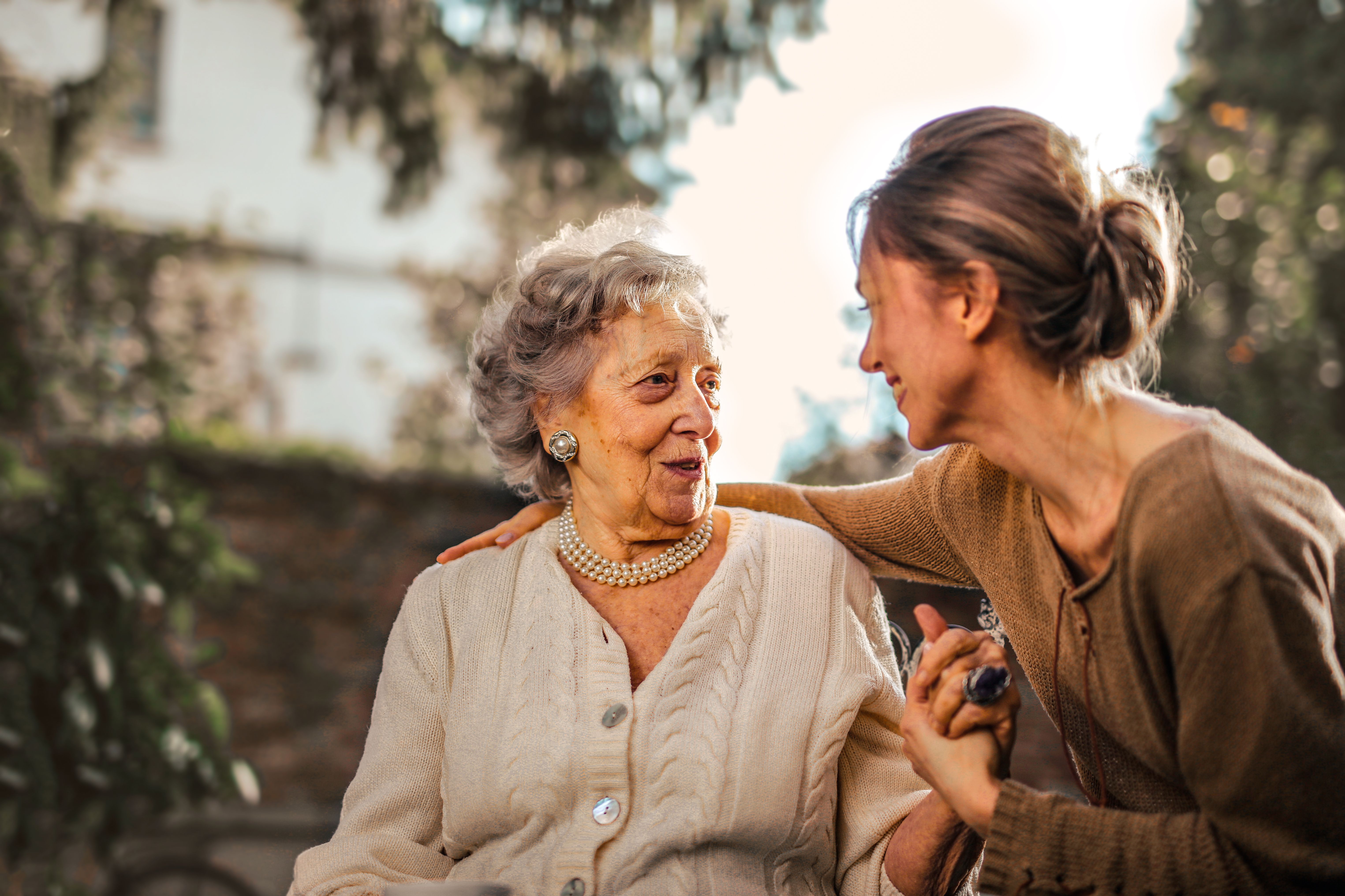 low-angle-of-cheerful-aged-lady-and-adult-woman-in-casual-clothes-holding-hands- - andrea-piacquadio (pexels)
