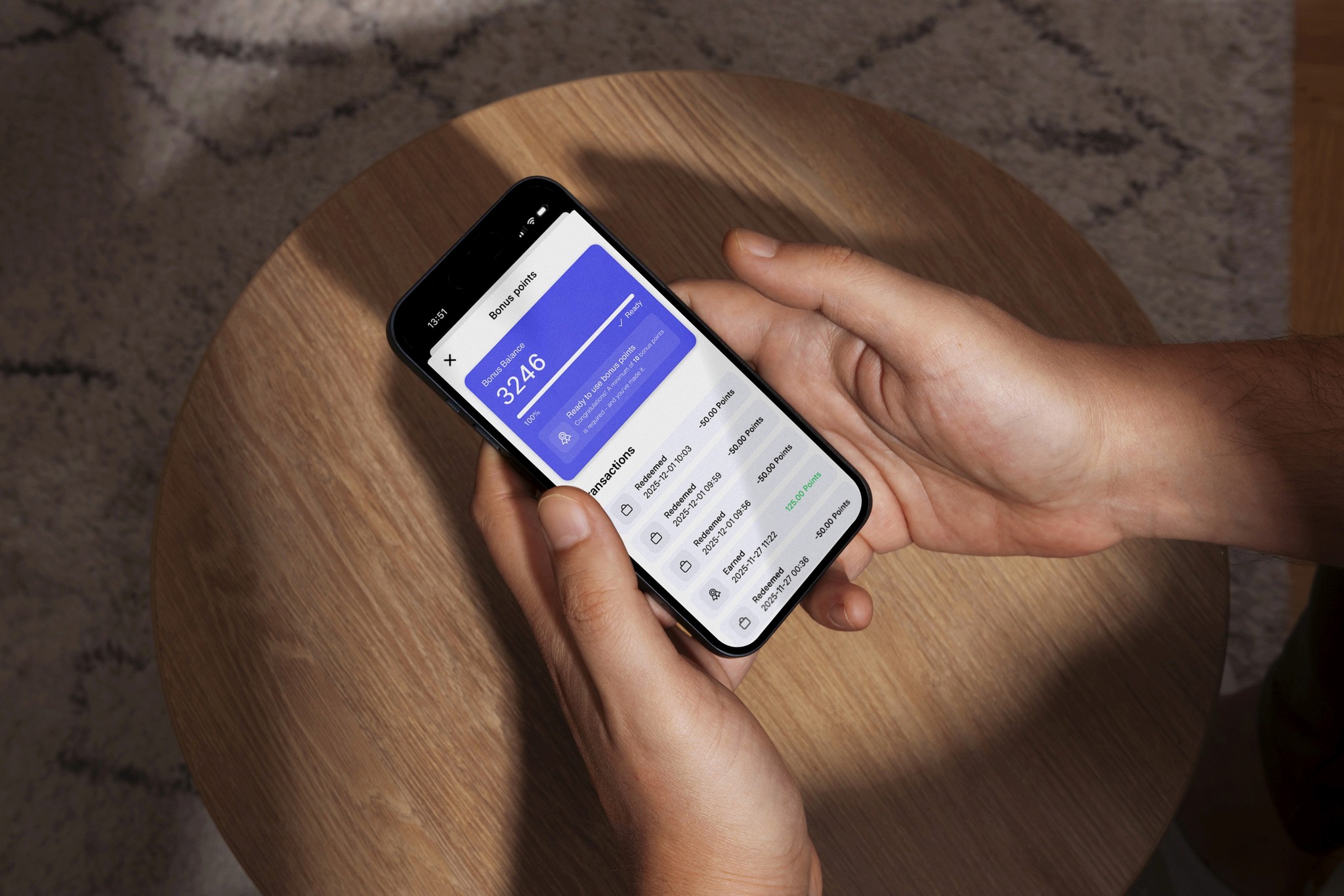 Man holding a smartphone showing an app with statistics.