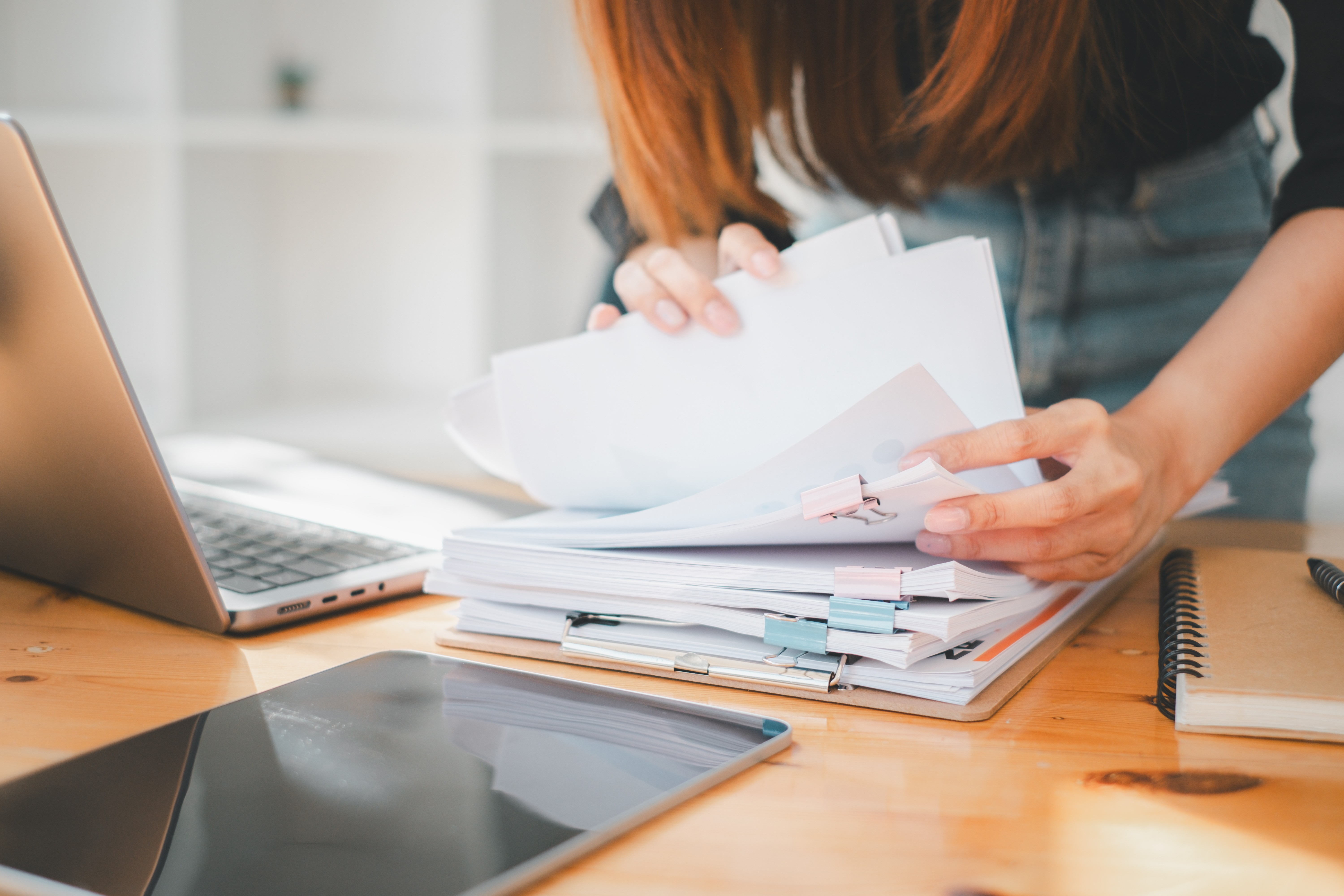 Business woman working in Stacks of paper files.