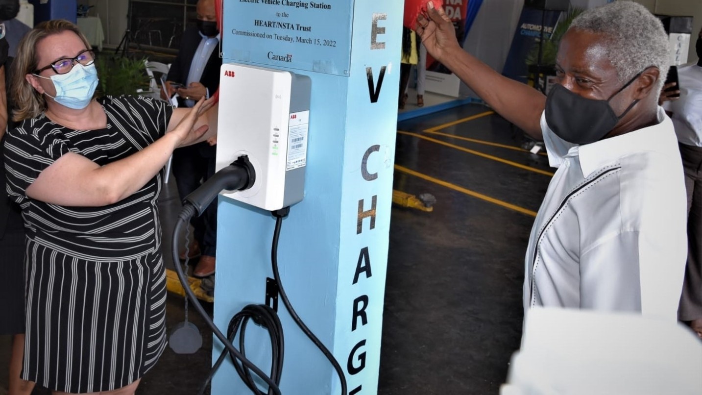 People holding EV charger