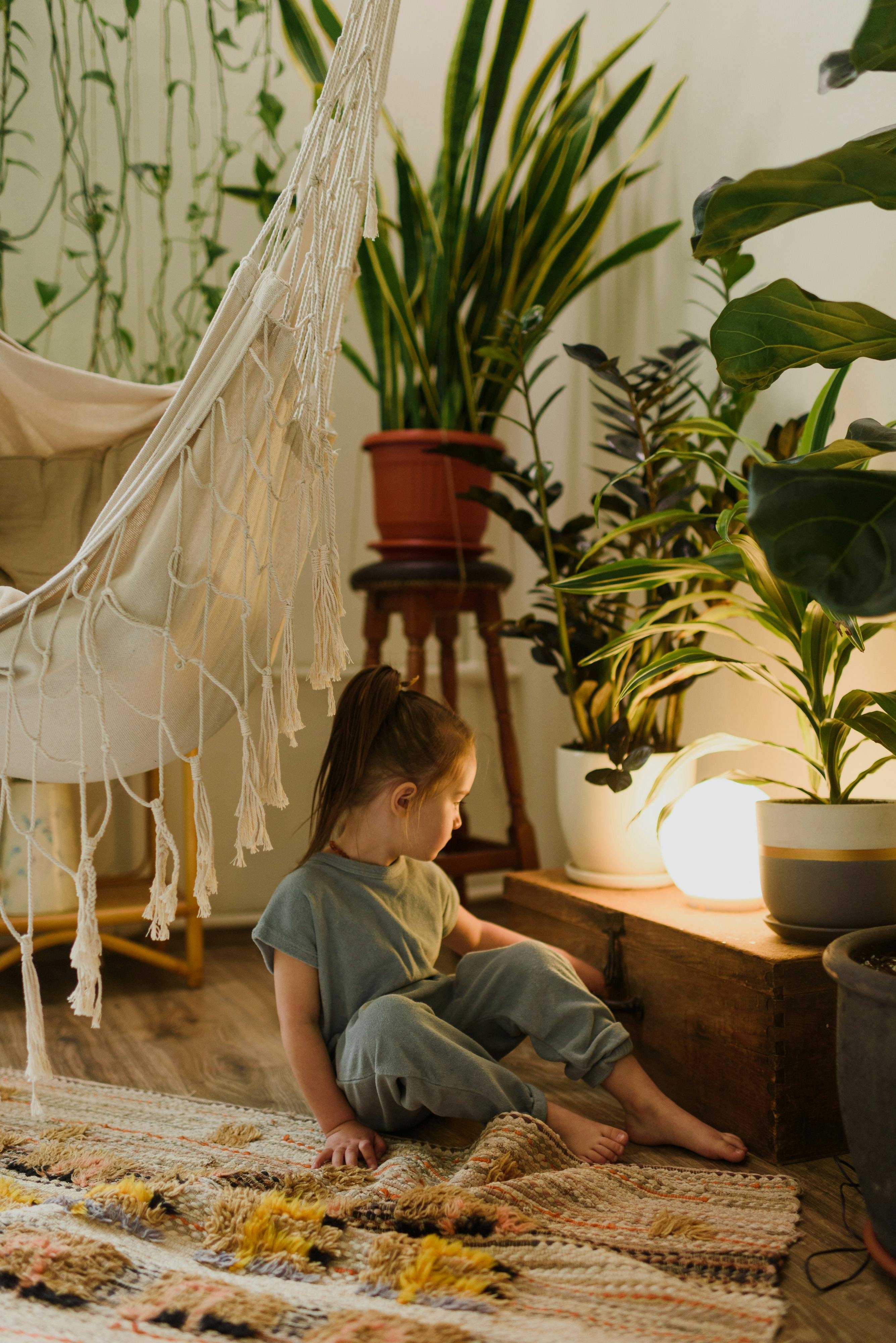 A room featuring bamboo flooring, natural fiber rugs, and indoor plants.