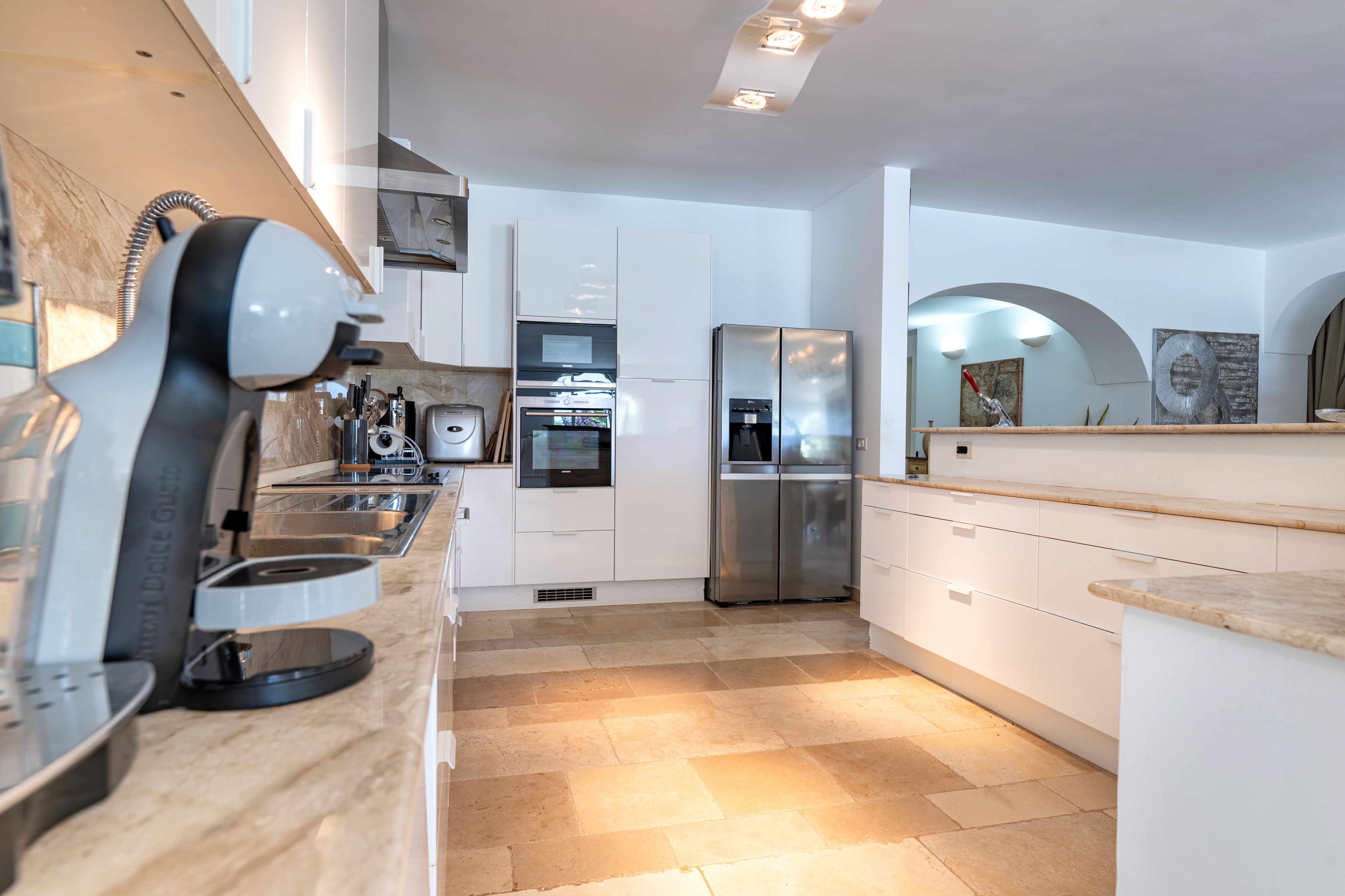 Modern hillside home with terracotta urn and mountain view