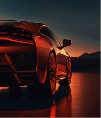 A red sports car silhouetted against a vibrant sunset sky, highlighting its sleek design and dynamic presence.