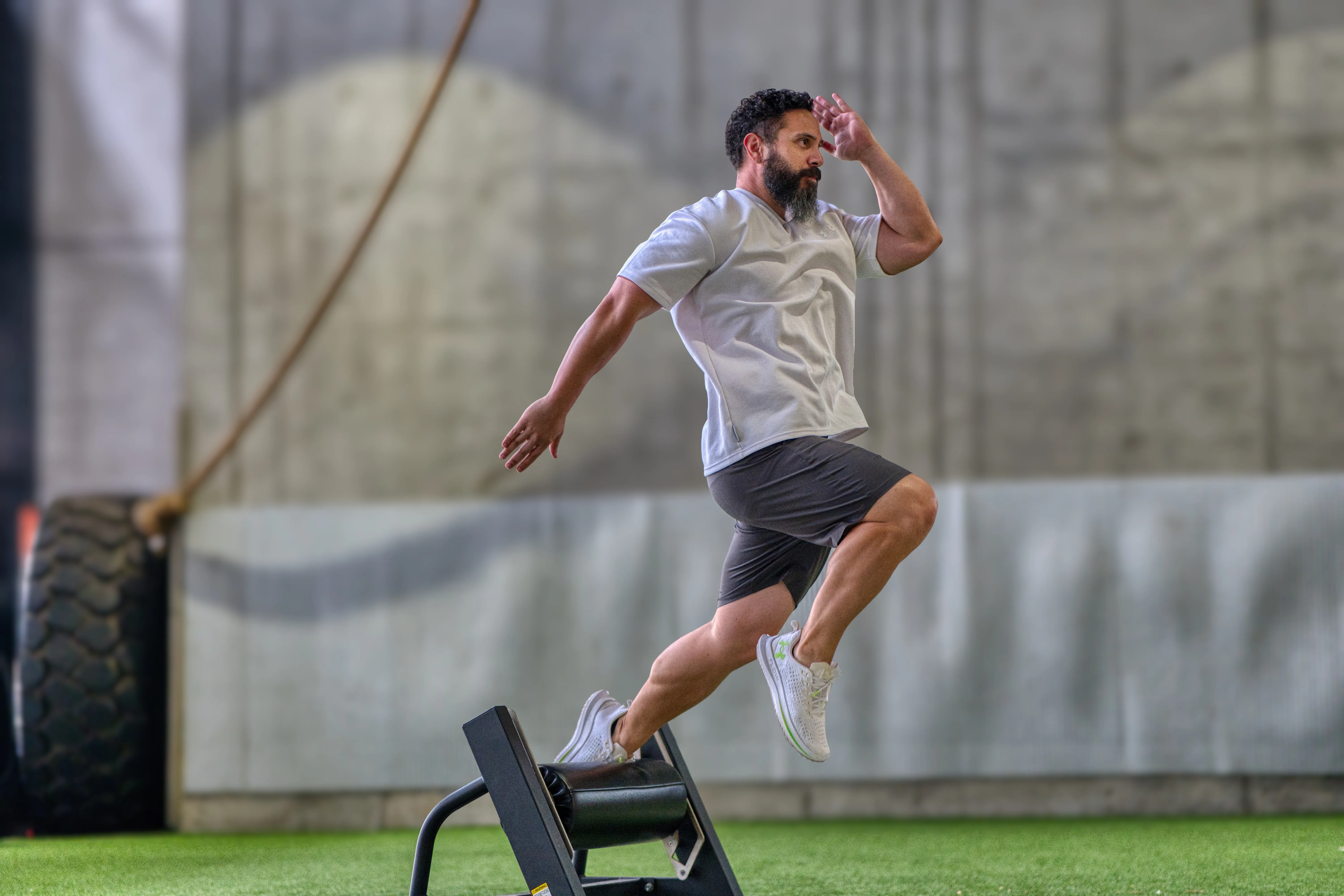 Jared high-fiving a client during a training session at a private gym