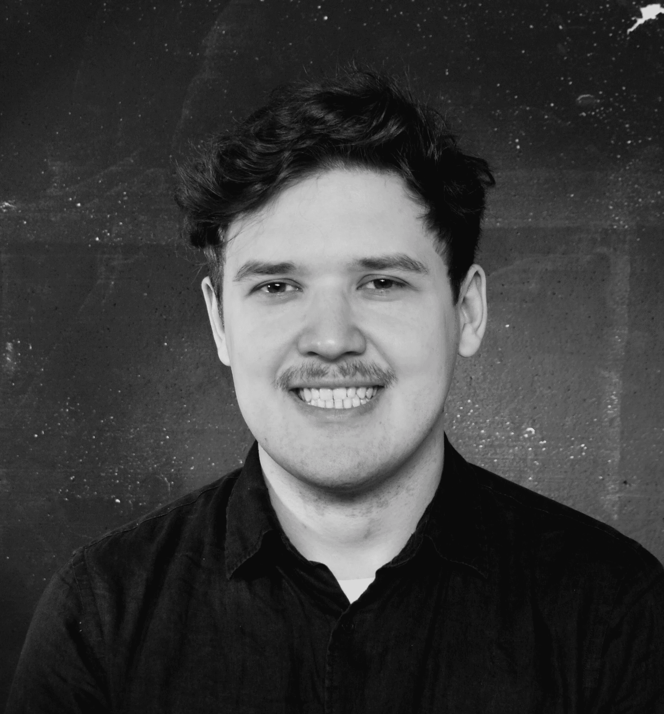 a black and white photo of a man with a mustache