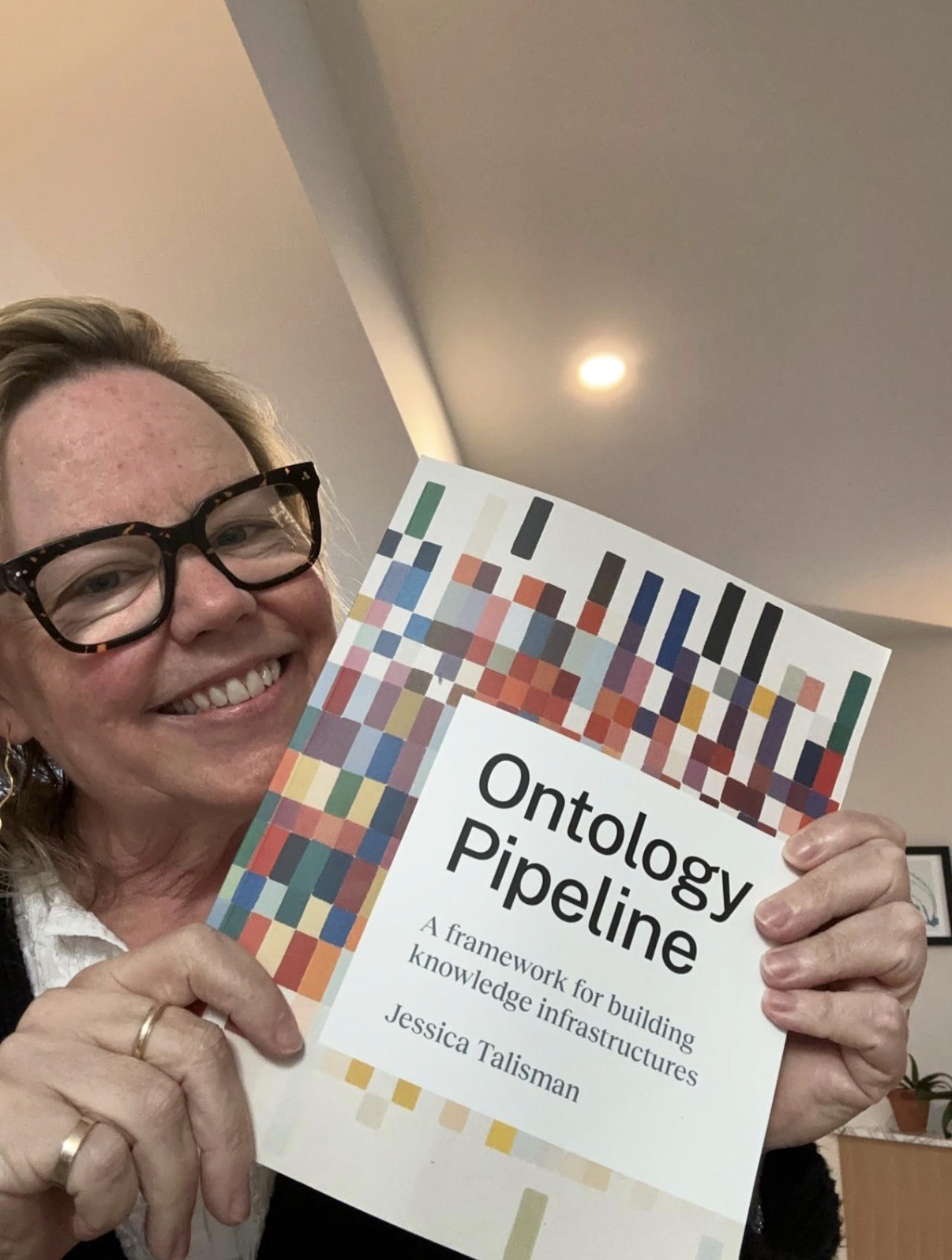 Jessica Talisman holding a copy of Ontology Pipeline.