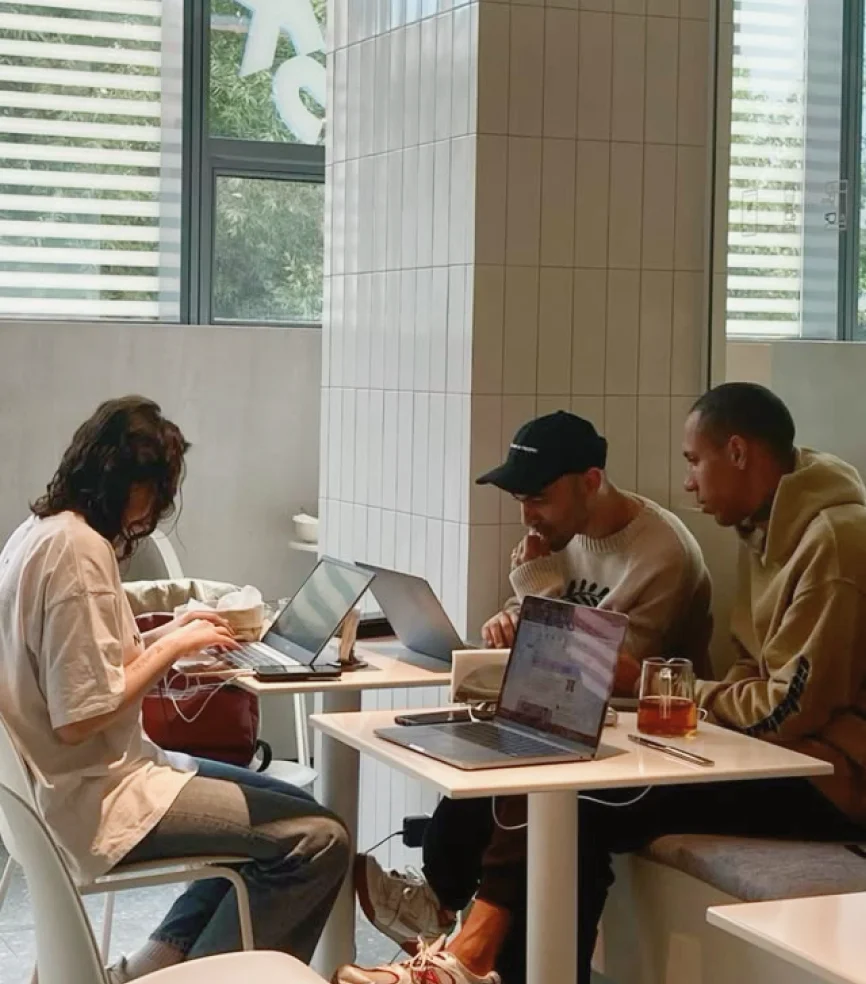 People working on laptops in cafe