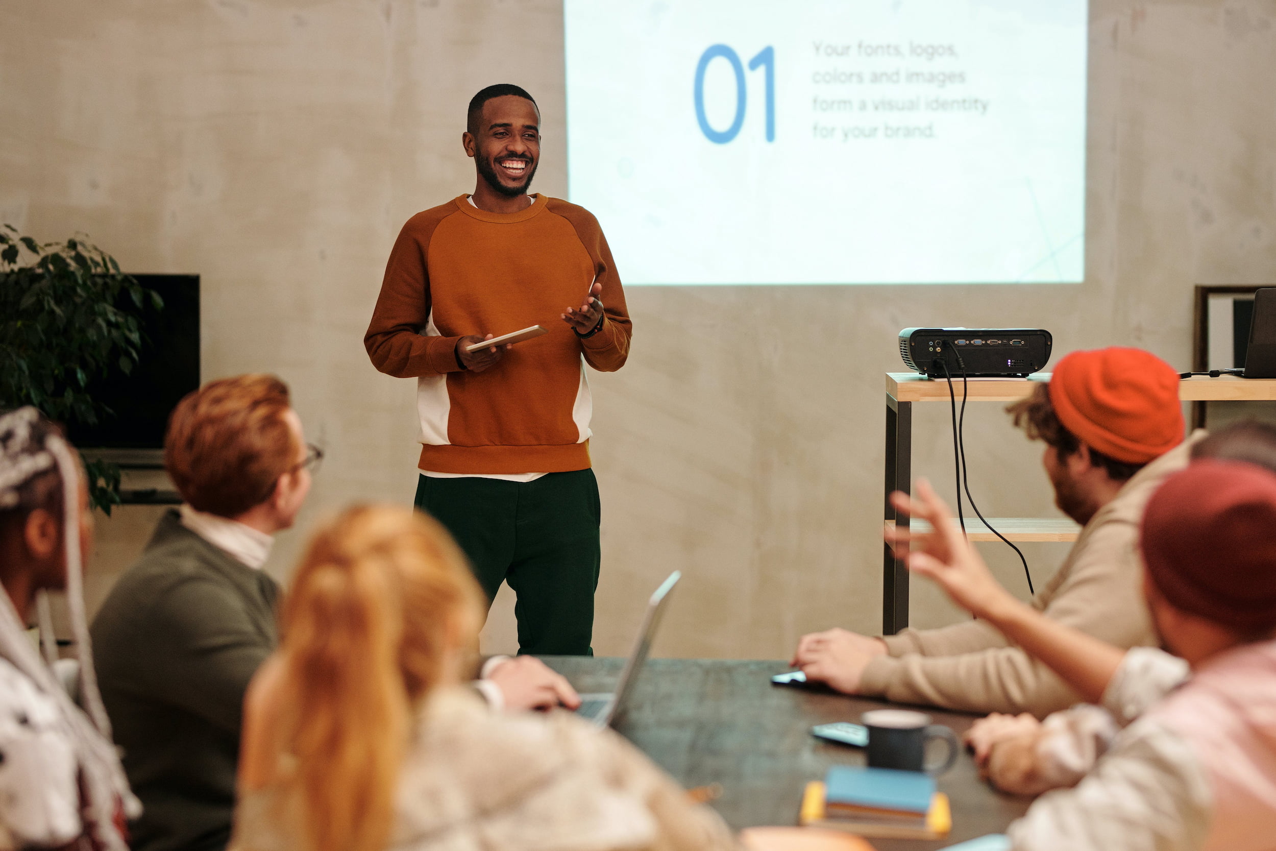 young man giving presentation to group of people
