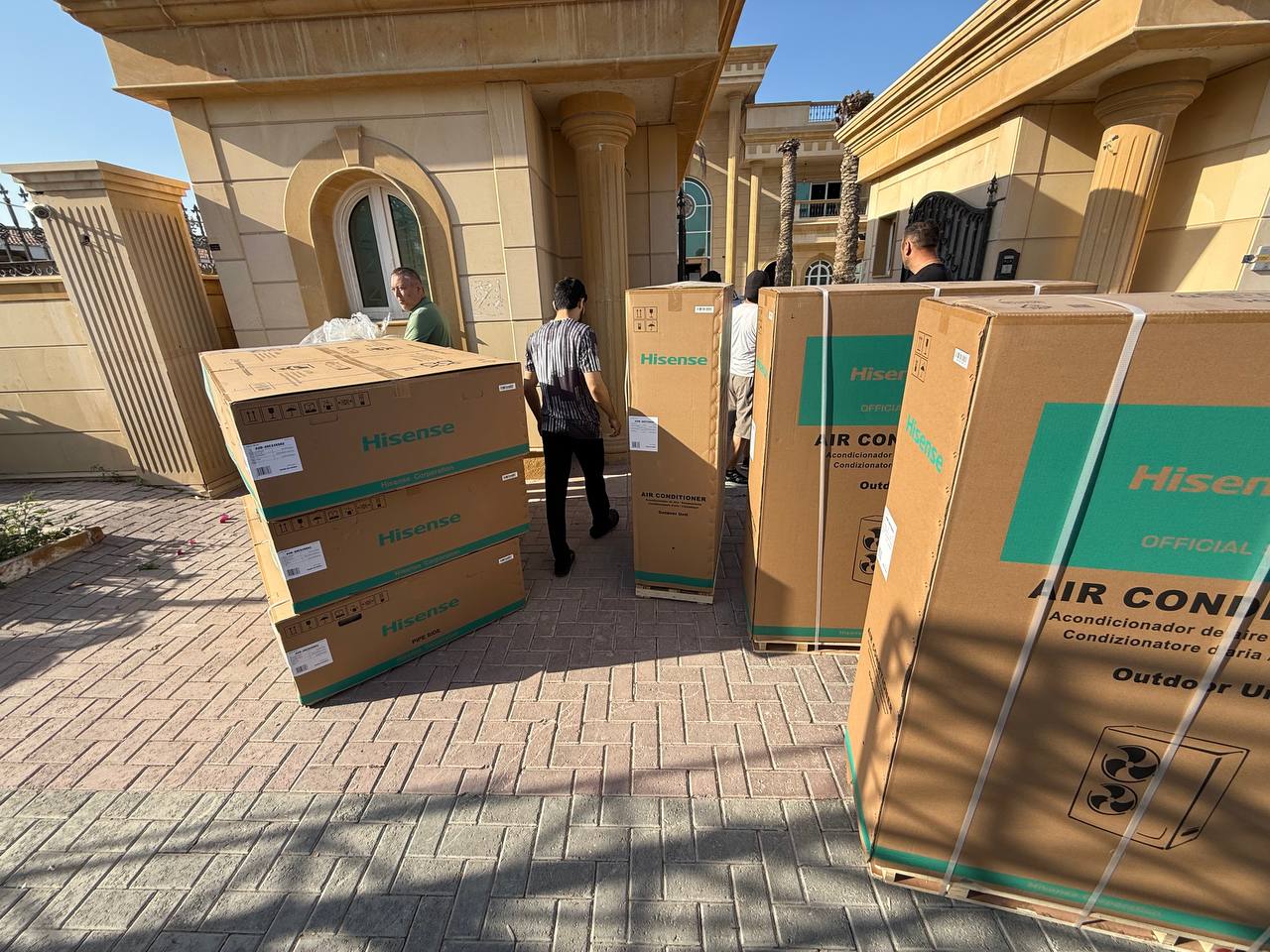 Crew delivering equipment at a Santa Barbara villa entrance.