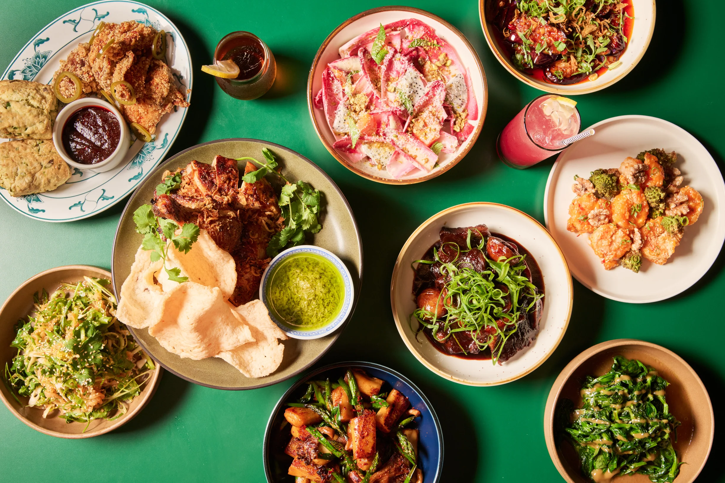 A colorful spread of Potluck Club’s most popular dishes, including Salt and Pepper Chicken and Biscuits, Oyster Mushroom Rice Rolls with Steak, and vibrant Cantonese-inspired sides, perfect for sharing family-style.