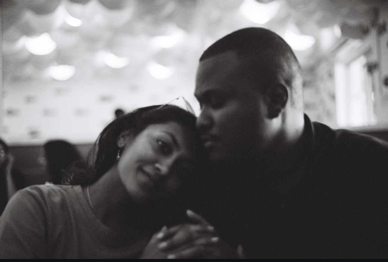An orange cube-shaped side table is shown.