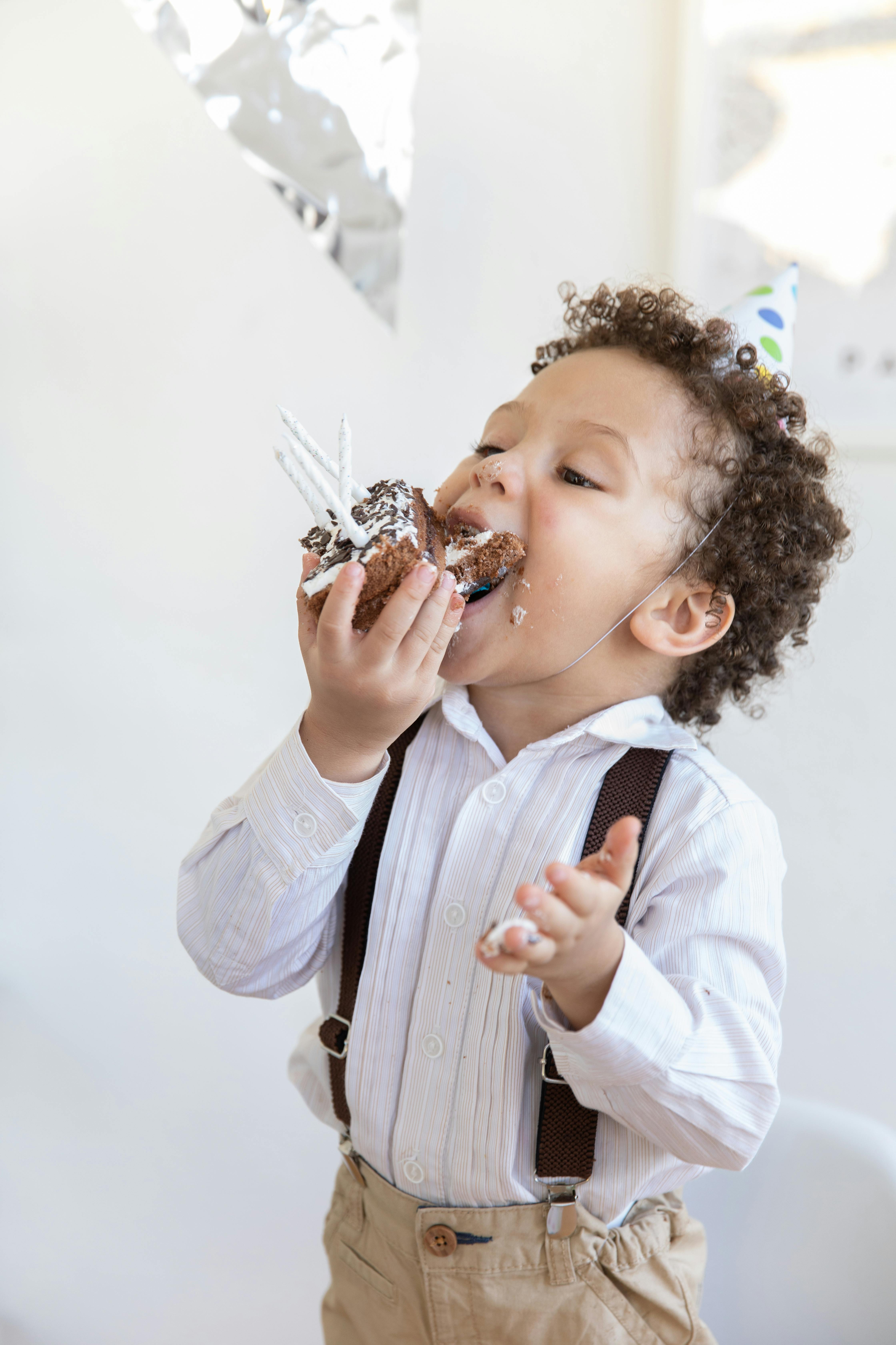 Little boy eating cake