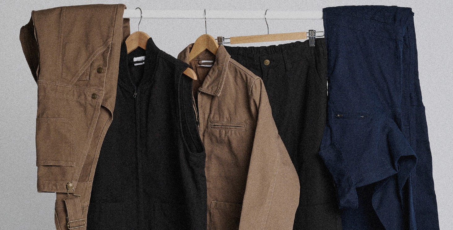 A clothing rack holding various Ascolour clothing products on hangers.