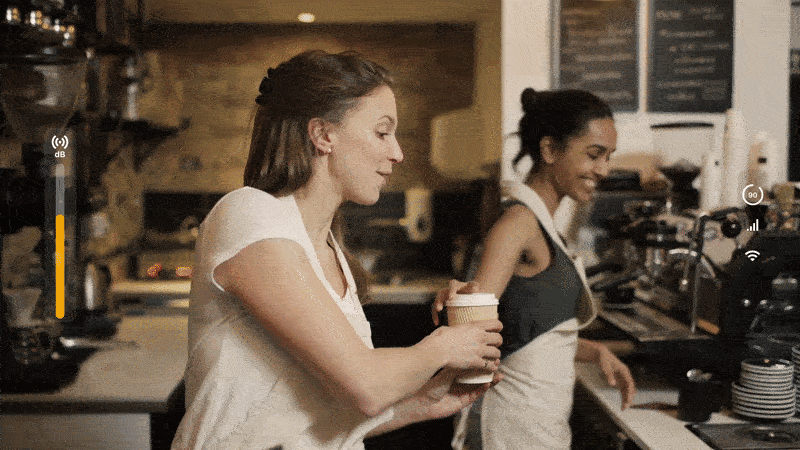 A lady handing over coffee and caption appears as she speaks