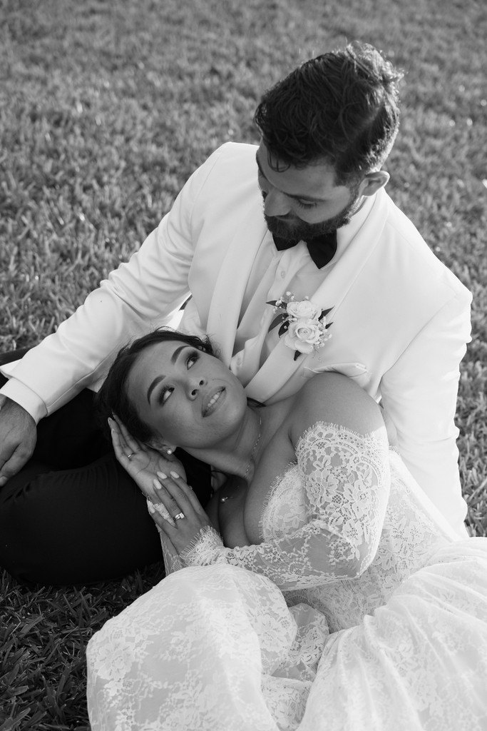     Palm Beach wedding photographer captures a bride and groom embracing in a romantic black and white wedding portrait.