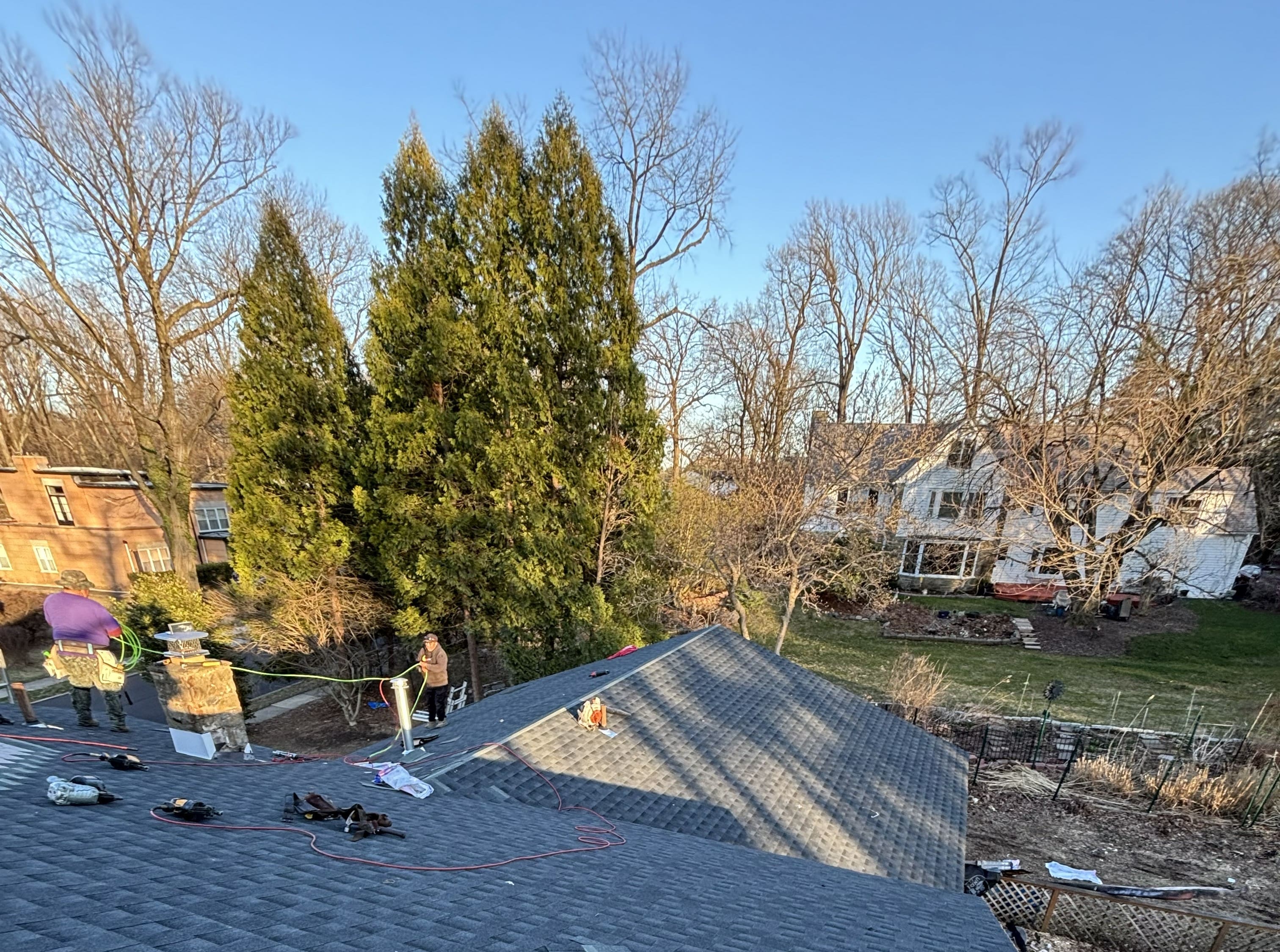 a man working on a roof with a power drill