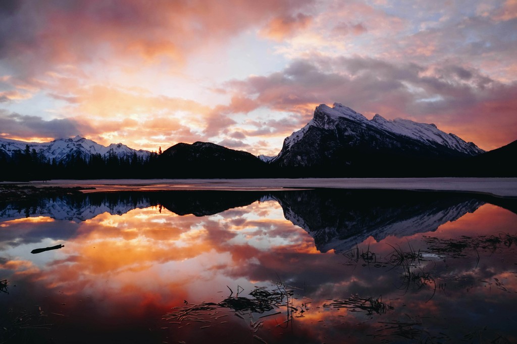 A lake with a snowy mountain in the background