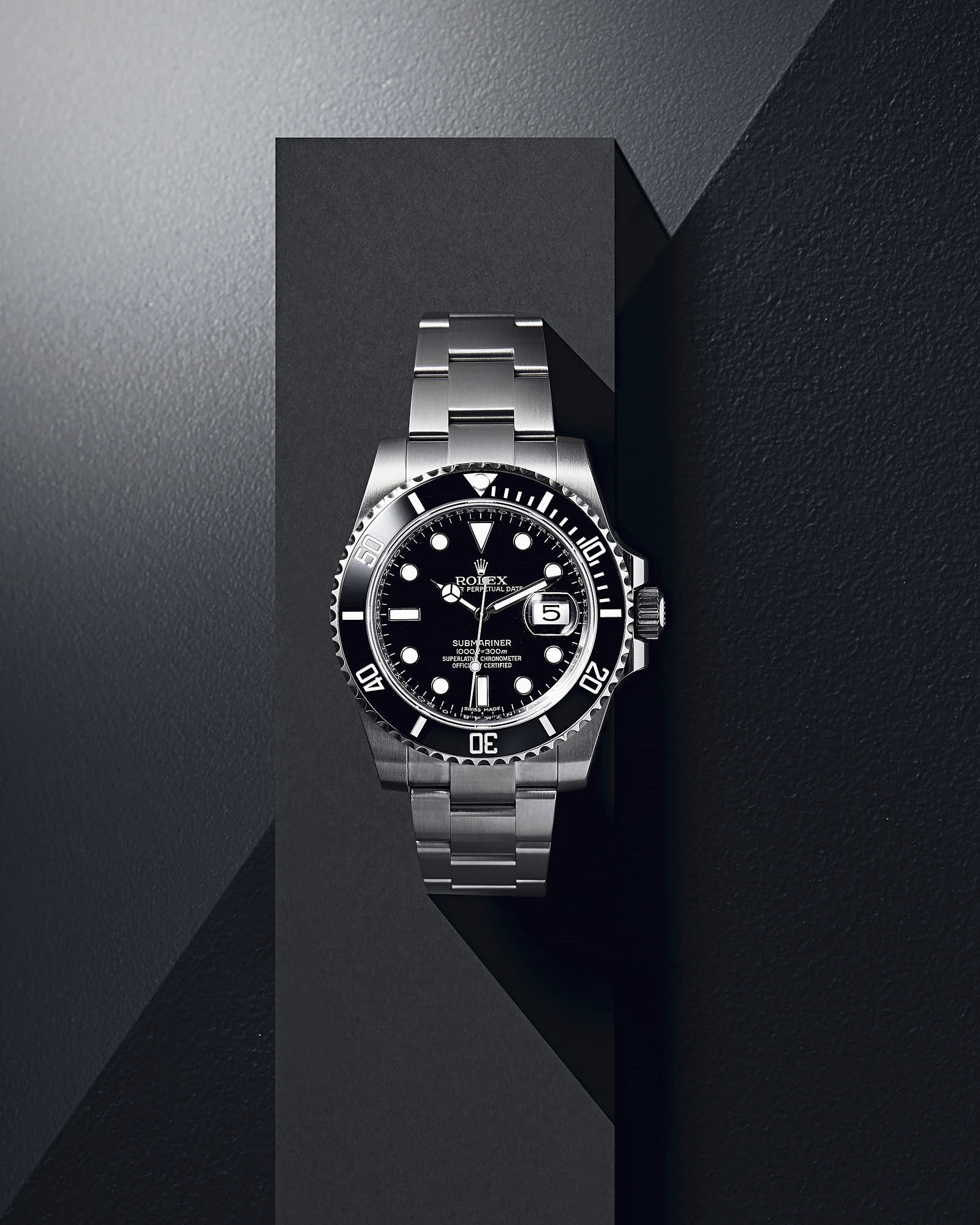 Luxury Rolex Submariner watch with stainless steel band and black dial.