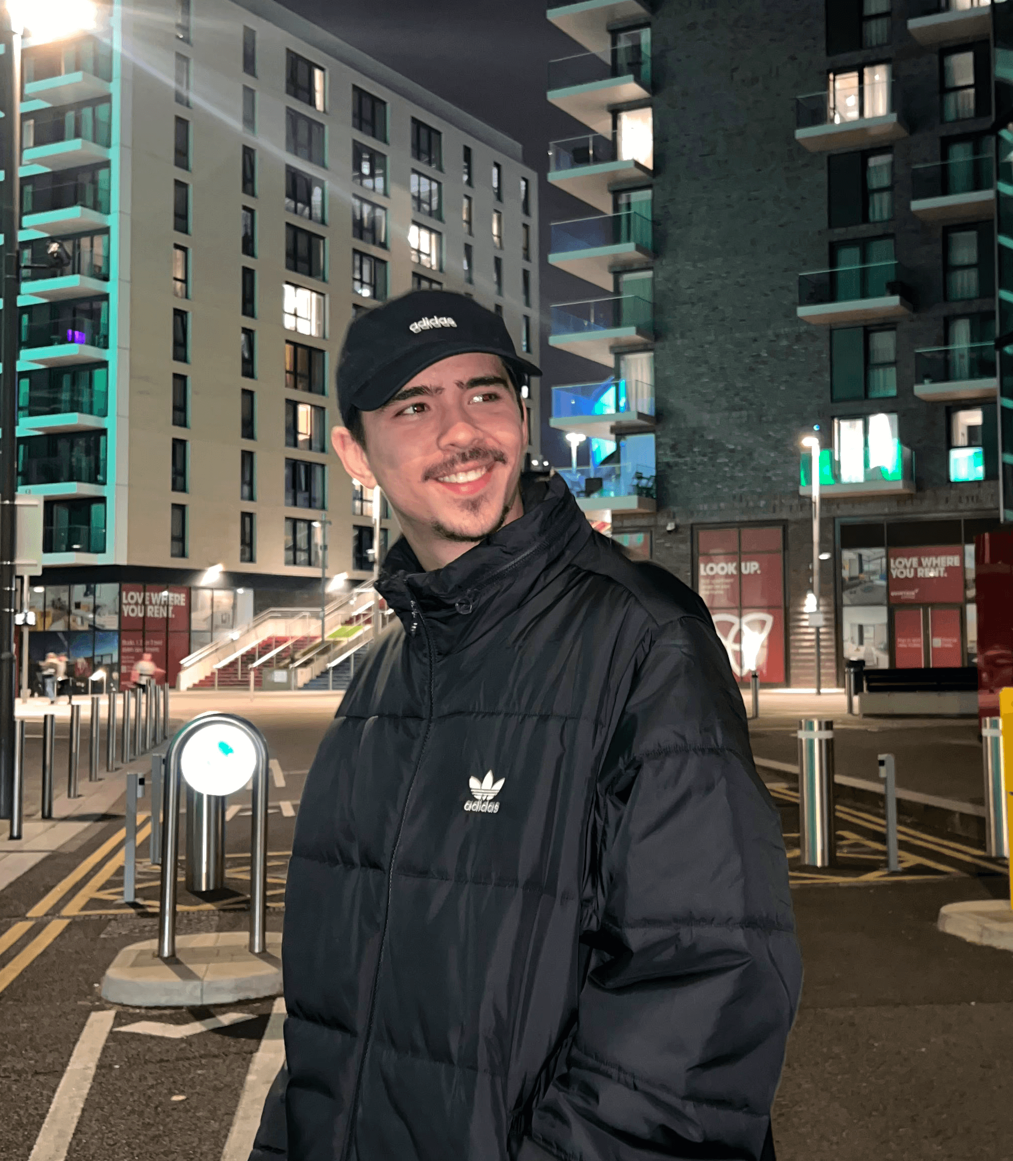 Man with black jacket looking forward and smiling