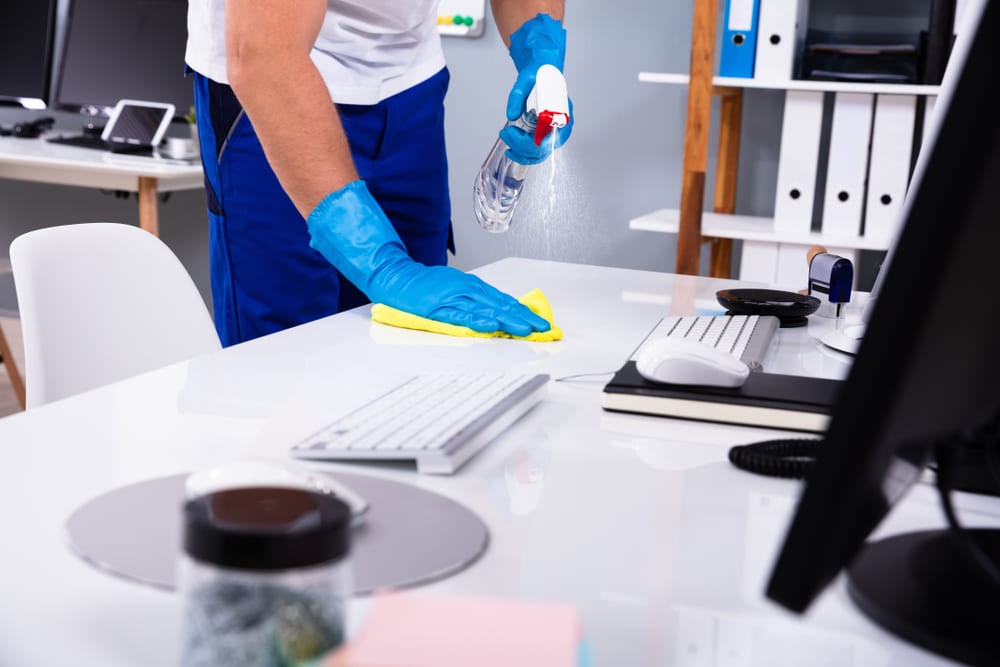 clean tech wiping desk