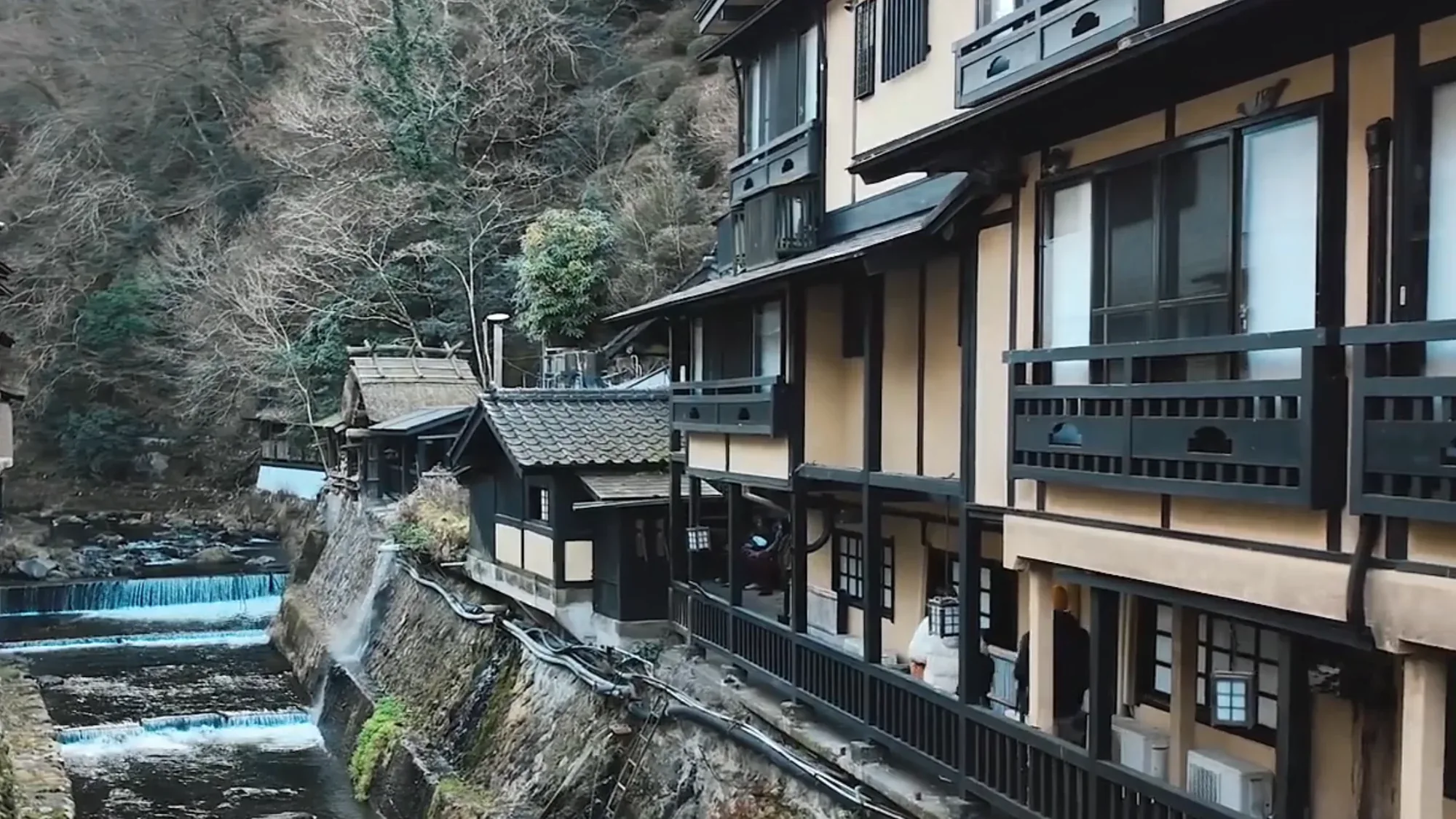 Tall timber inns standing above the river at Kurokawa Onsen