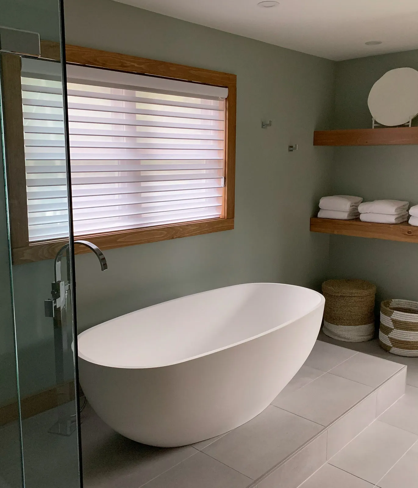 custom standing bathtub on precision ceramic tiling in primary bathroom.