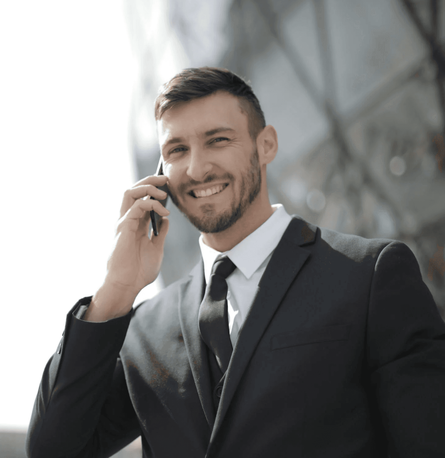 Minimalist profile shot of a man with long braids and a white shirt, set against a soft, light background.