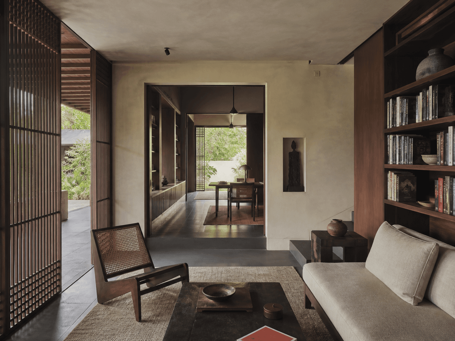 Serene interior architecture with teak screens and filtered courtyard light