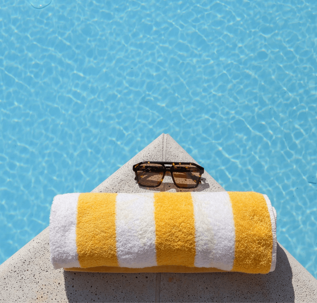poolside with towel and sunglasses