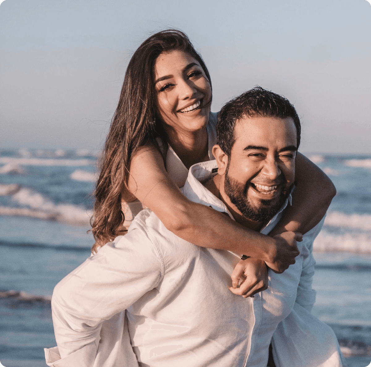 man in white dress shirt hugging woman in white dress