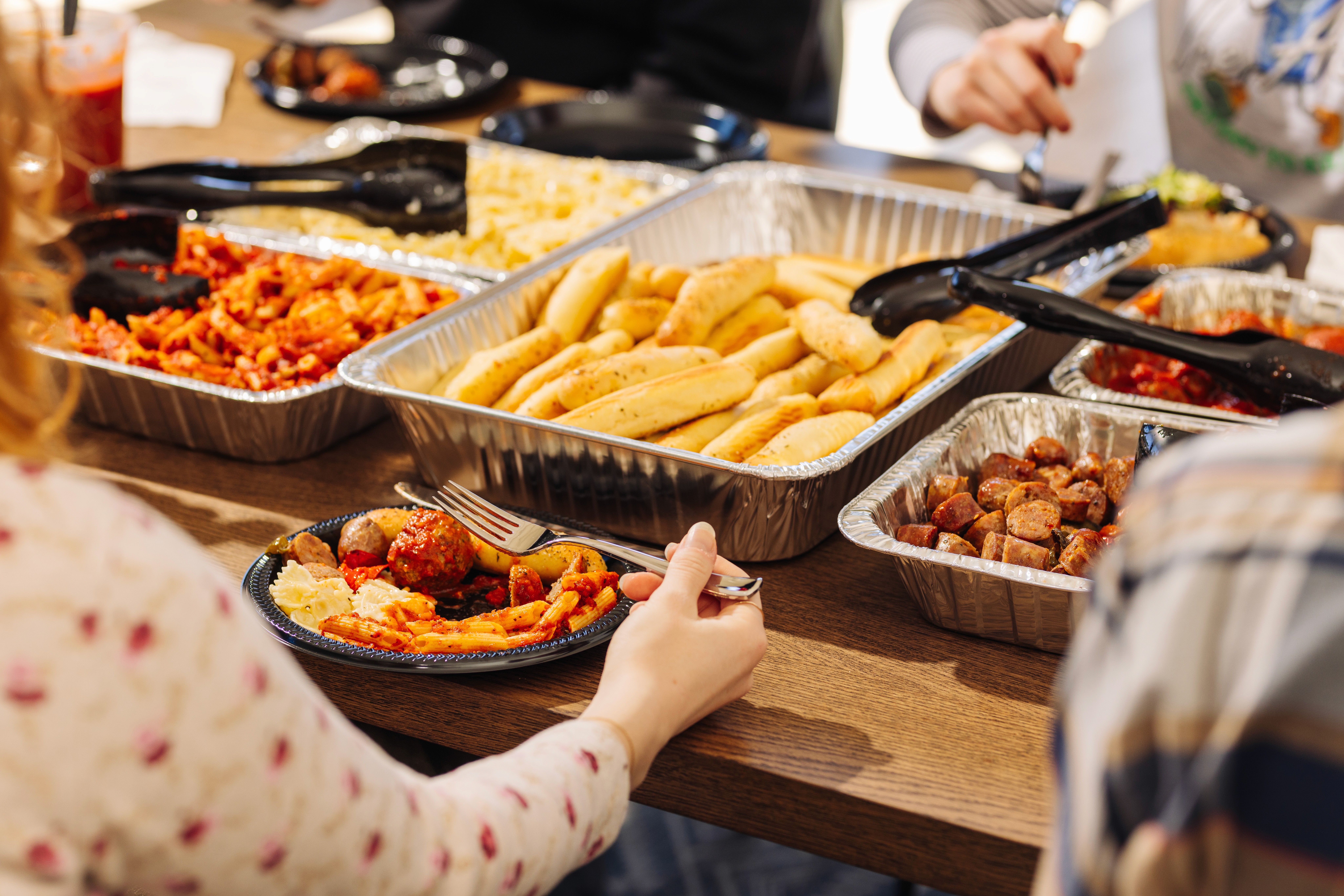 Chef plating a fried chicken sandwich