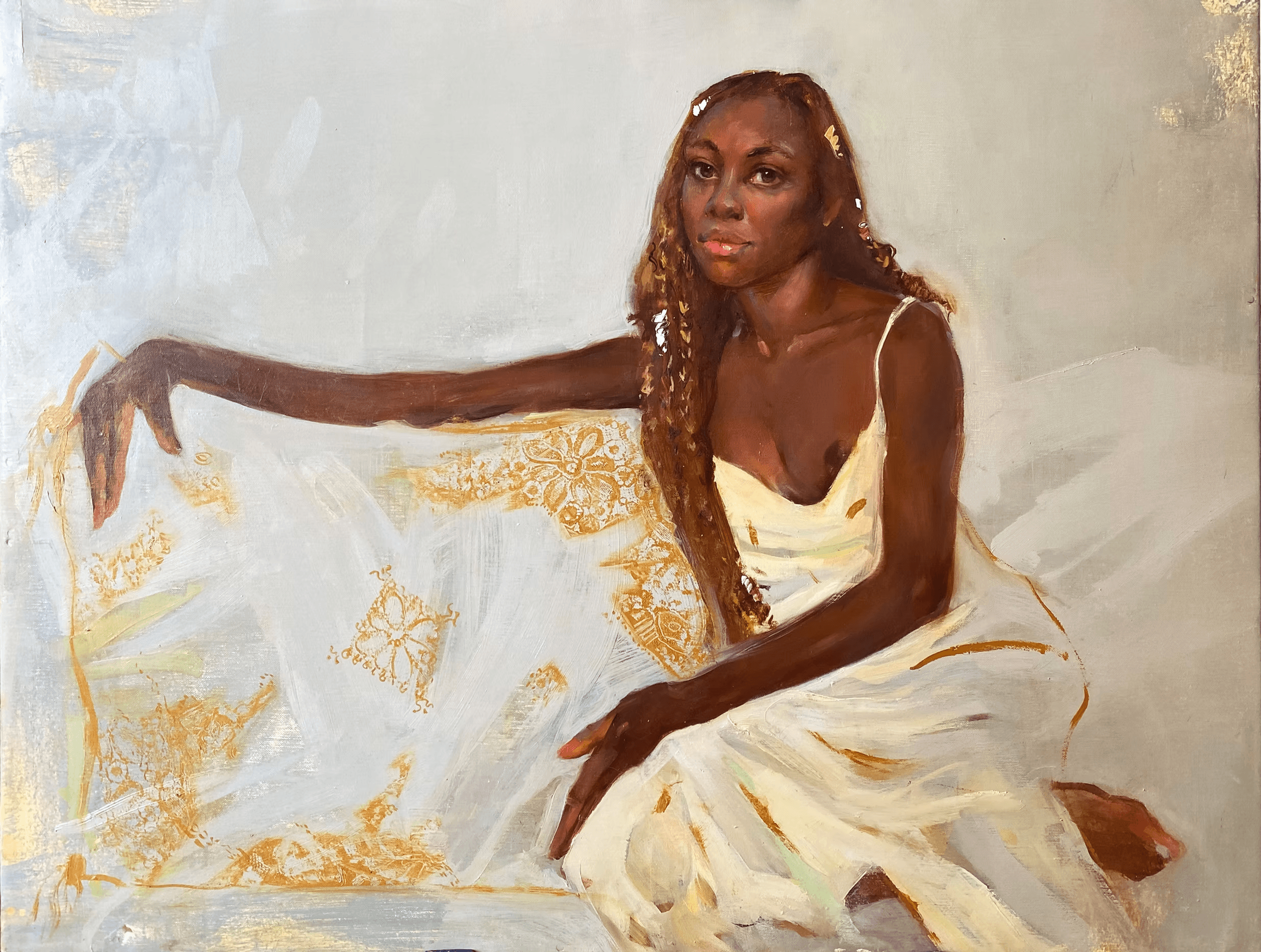 A serene portrait of a woman with long, braided hair, wearing a flowing white dress, elegantly seated with one arm draped over a golden-patterned fabric, set against a soft, neutral background.