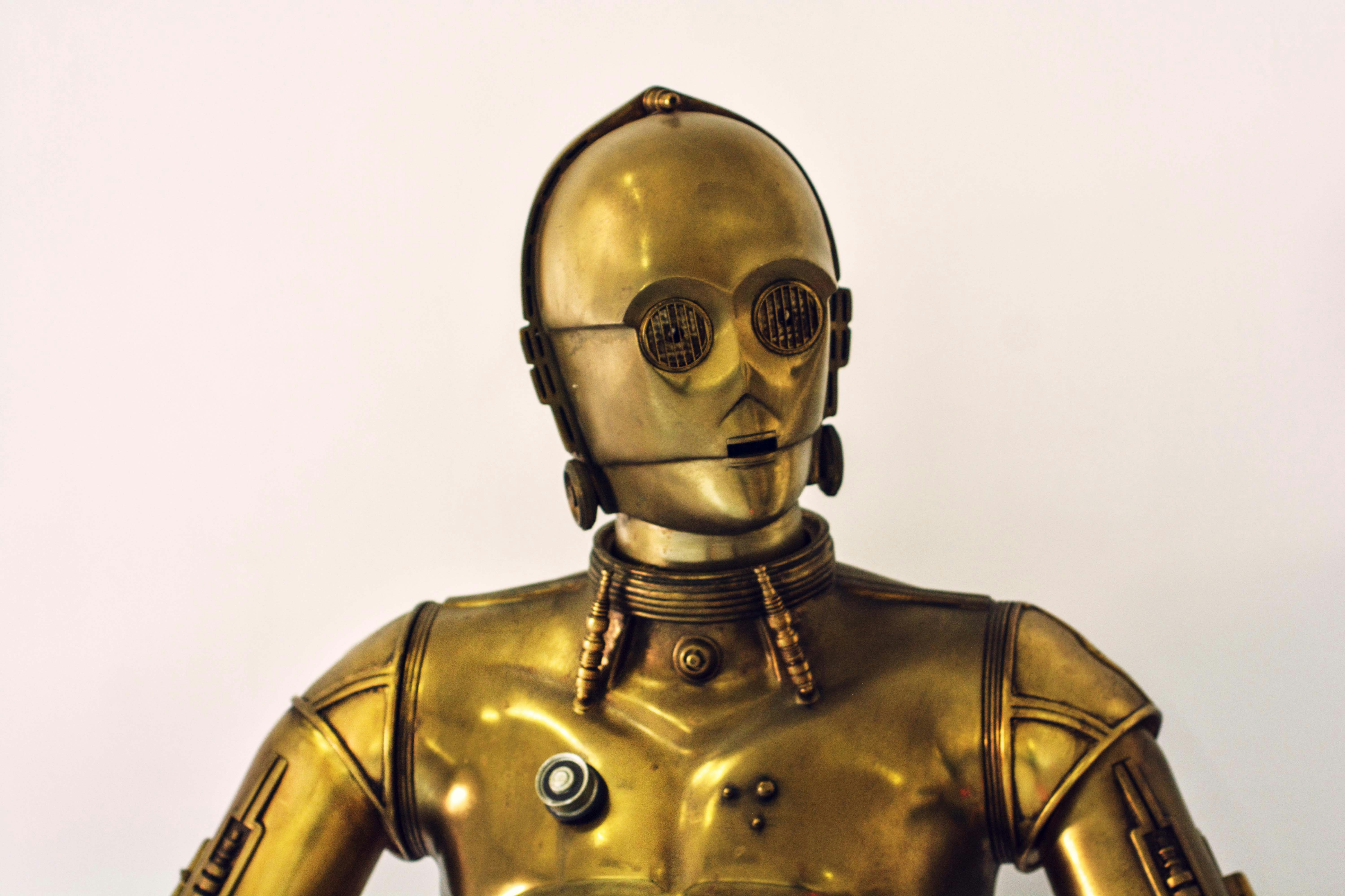 A golden humanoid robot against a plain background, symbolising how AI systems interpret brands in generative engines, perfect for illustrating why AI SEO is not SEO and why businesses must optimise for entity understanding in ChatGPT, Gemini and other answer engines.