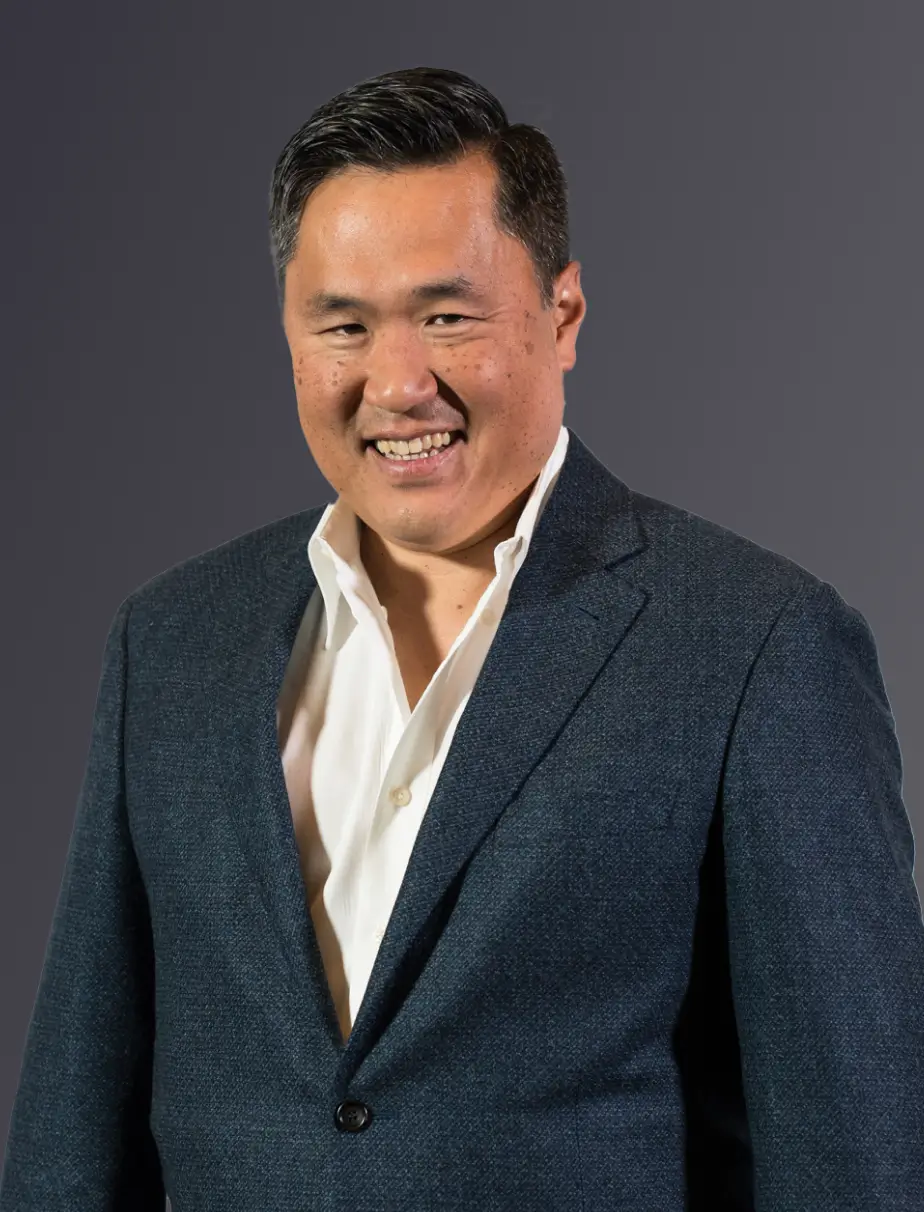 A smiling man in an outdoor landscape