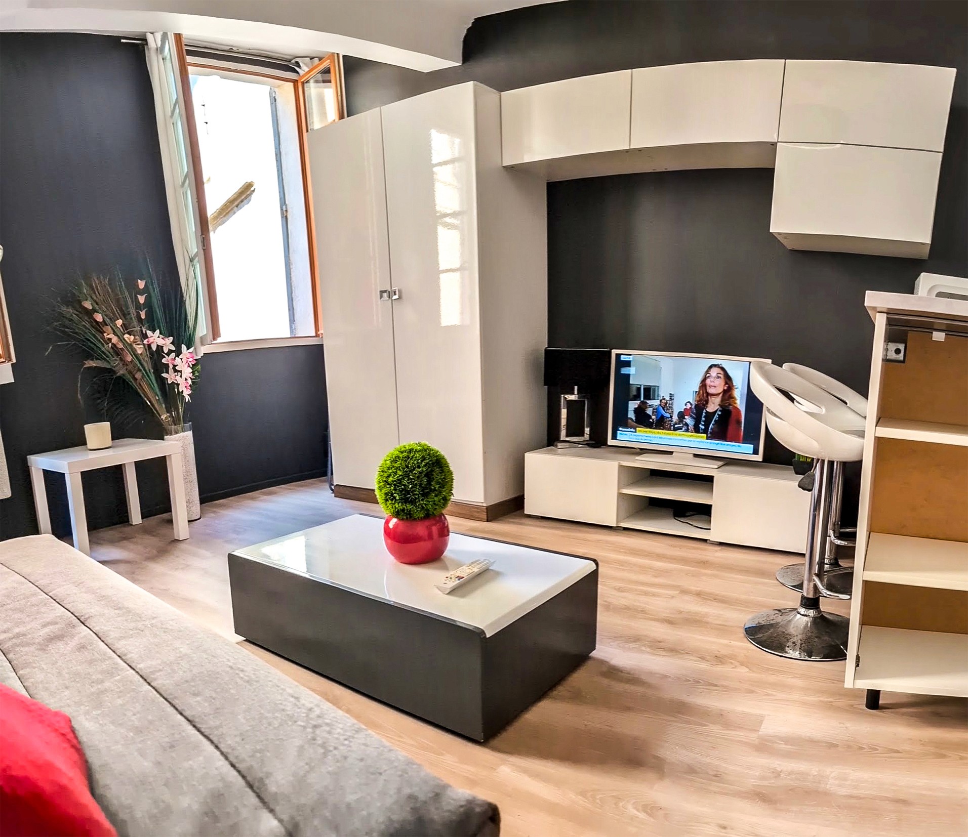 Modern interior with a minimalist design featuring curved rust-colored metal partitions, polished concrete floor, and subdued lighting, creating a warm, industrial ambiance.