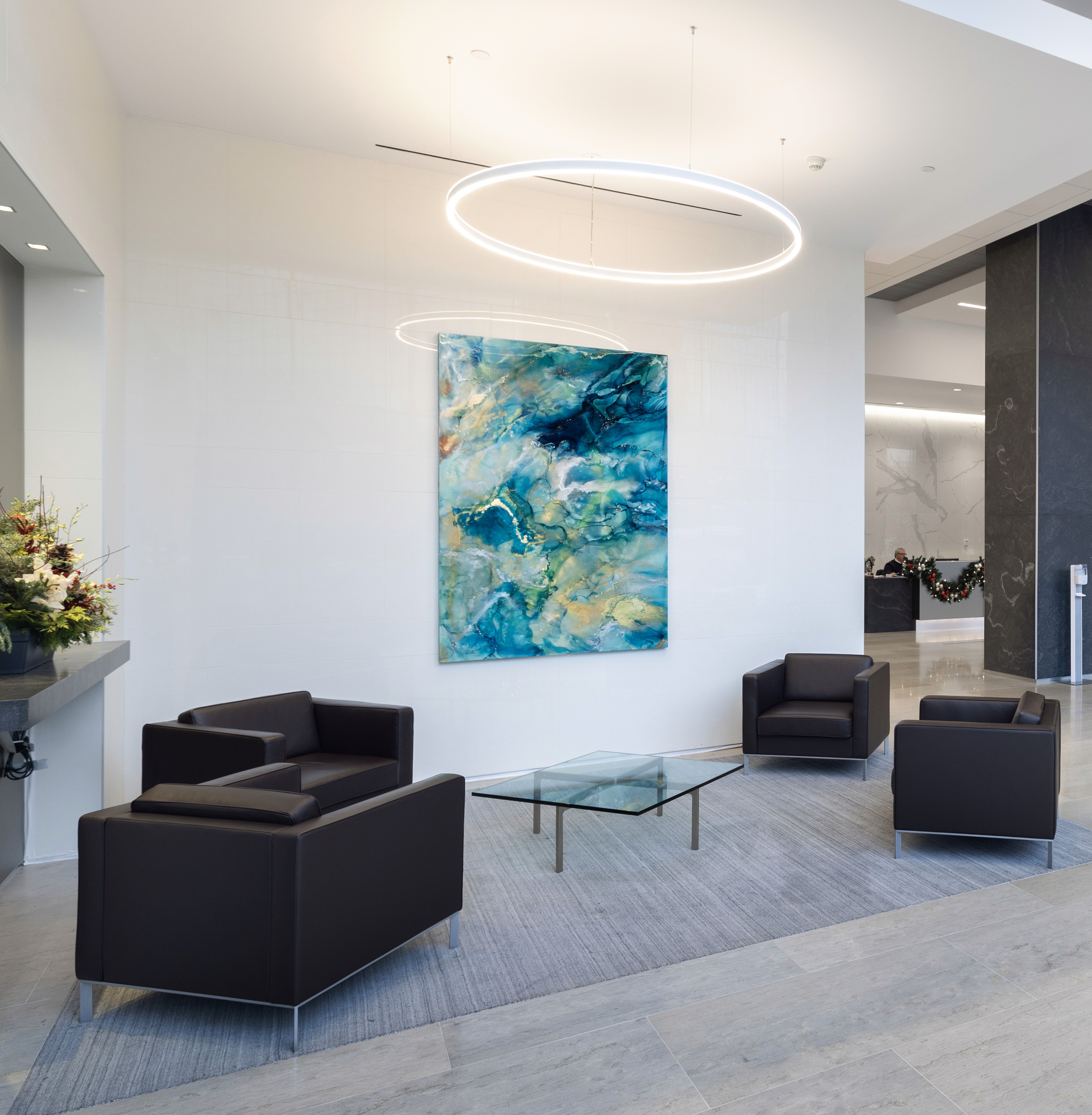 A woman observes framed black-and-white photographs in warm golden light