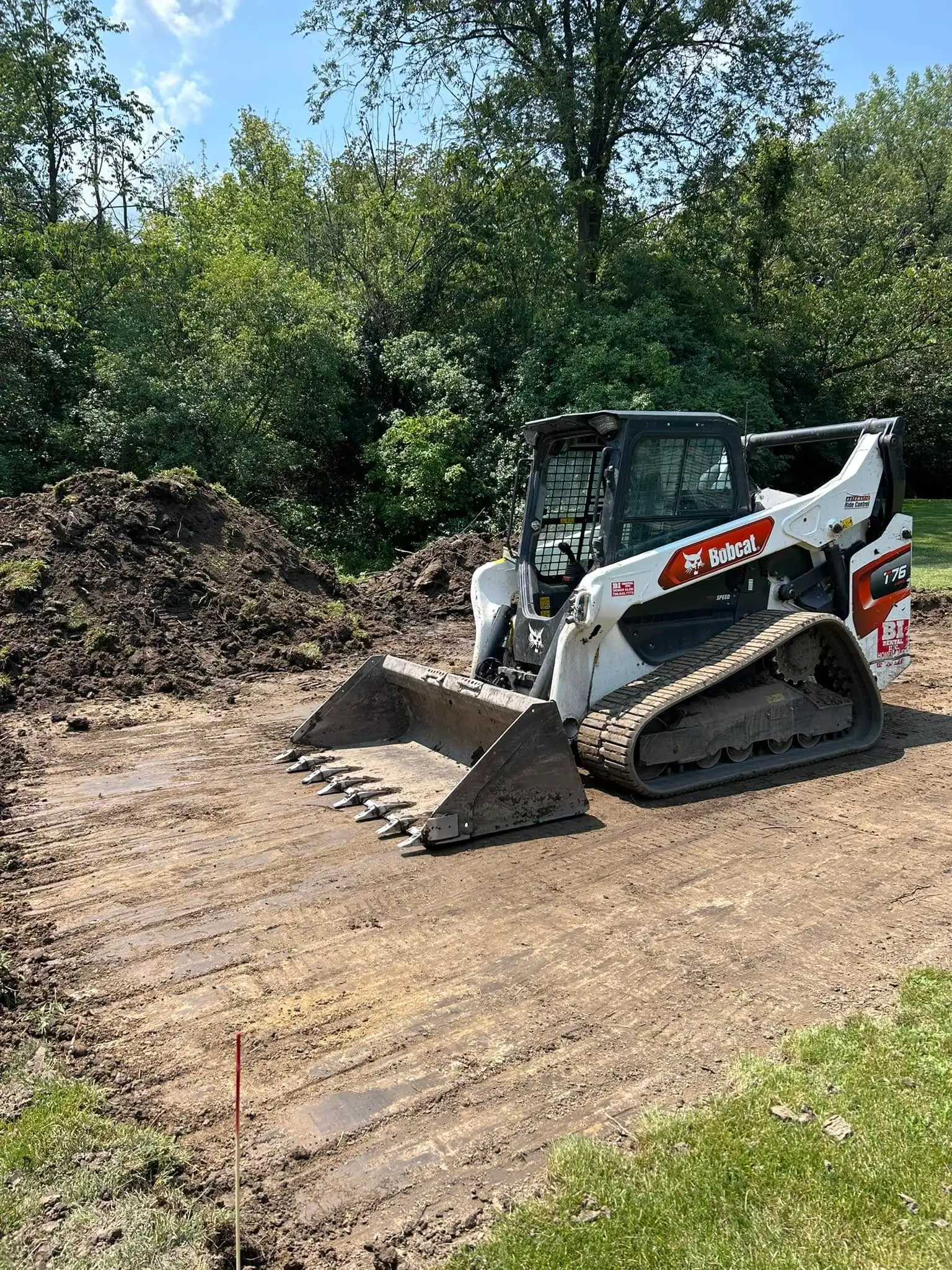 yellow and black excavator on brown soil