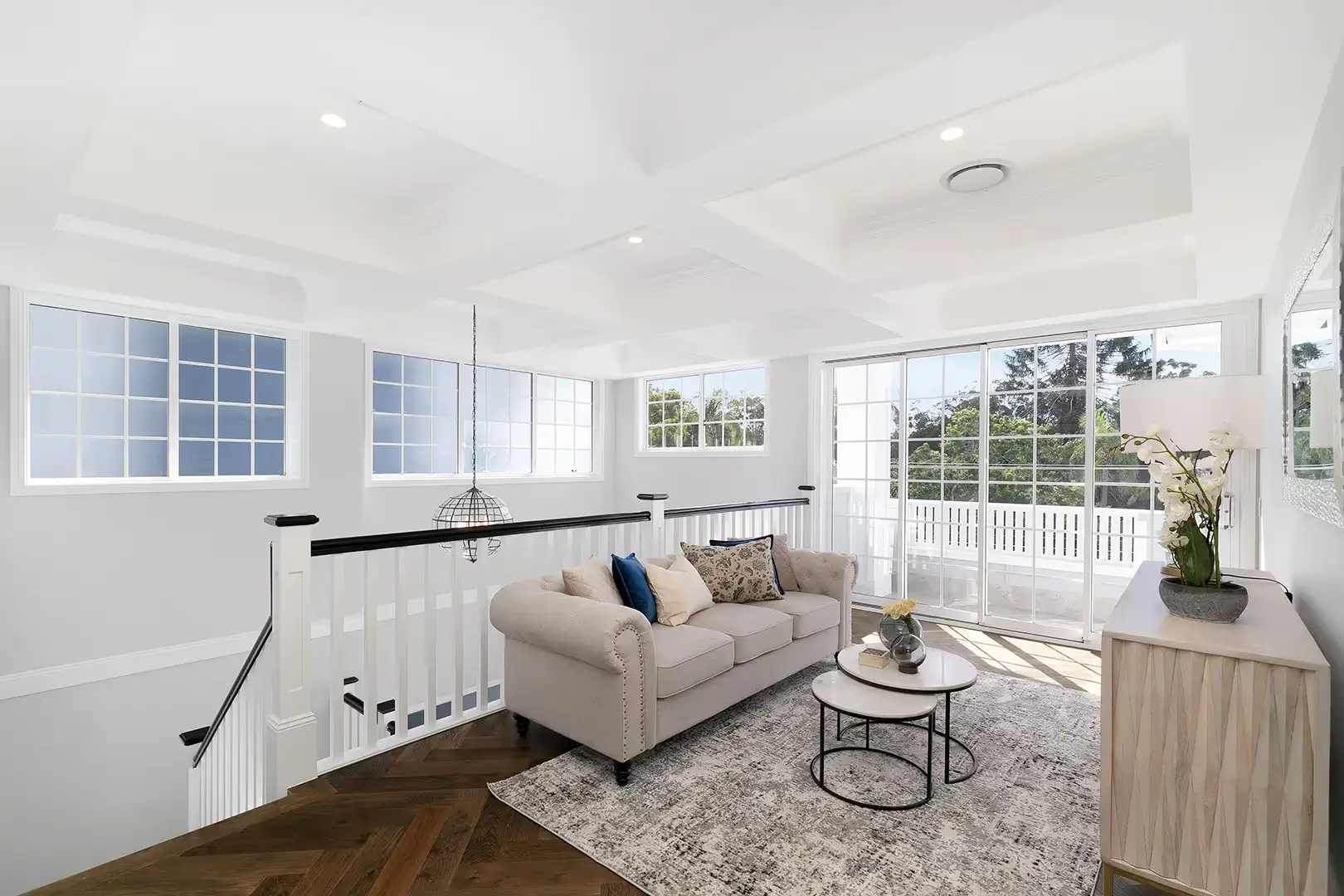 A living area at the top of the staircase with a view to one of the verandahs